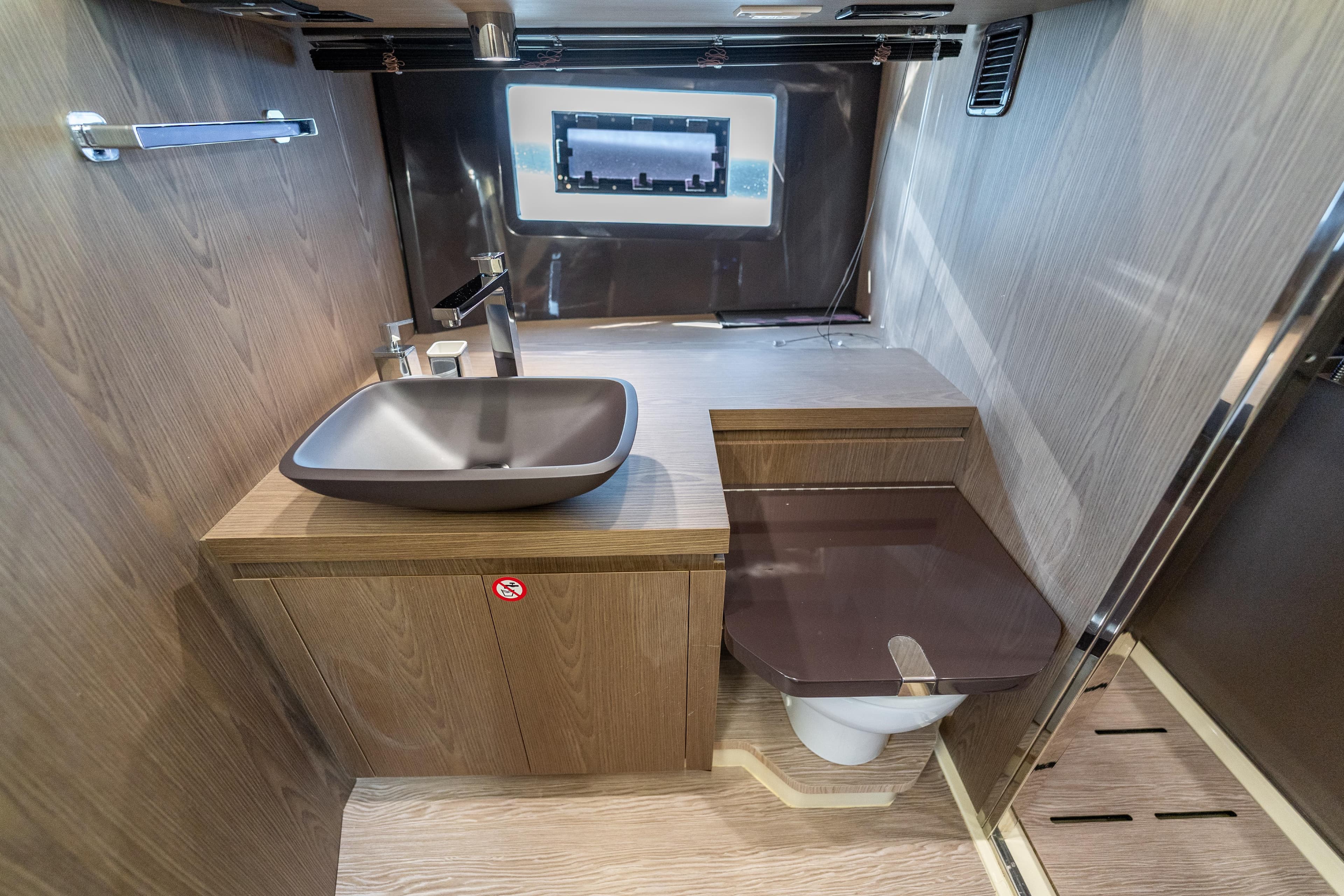 Luxurious bathroom interior of 2024 Invictus TT460 yacht with modern sink and toilet.