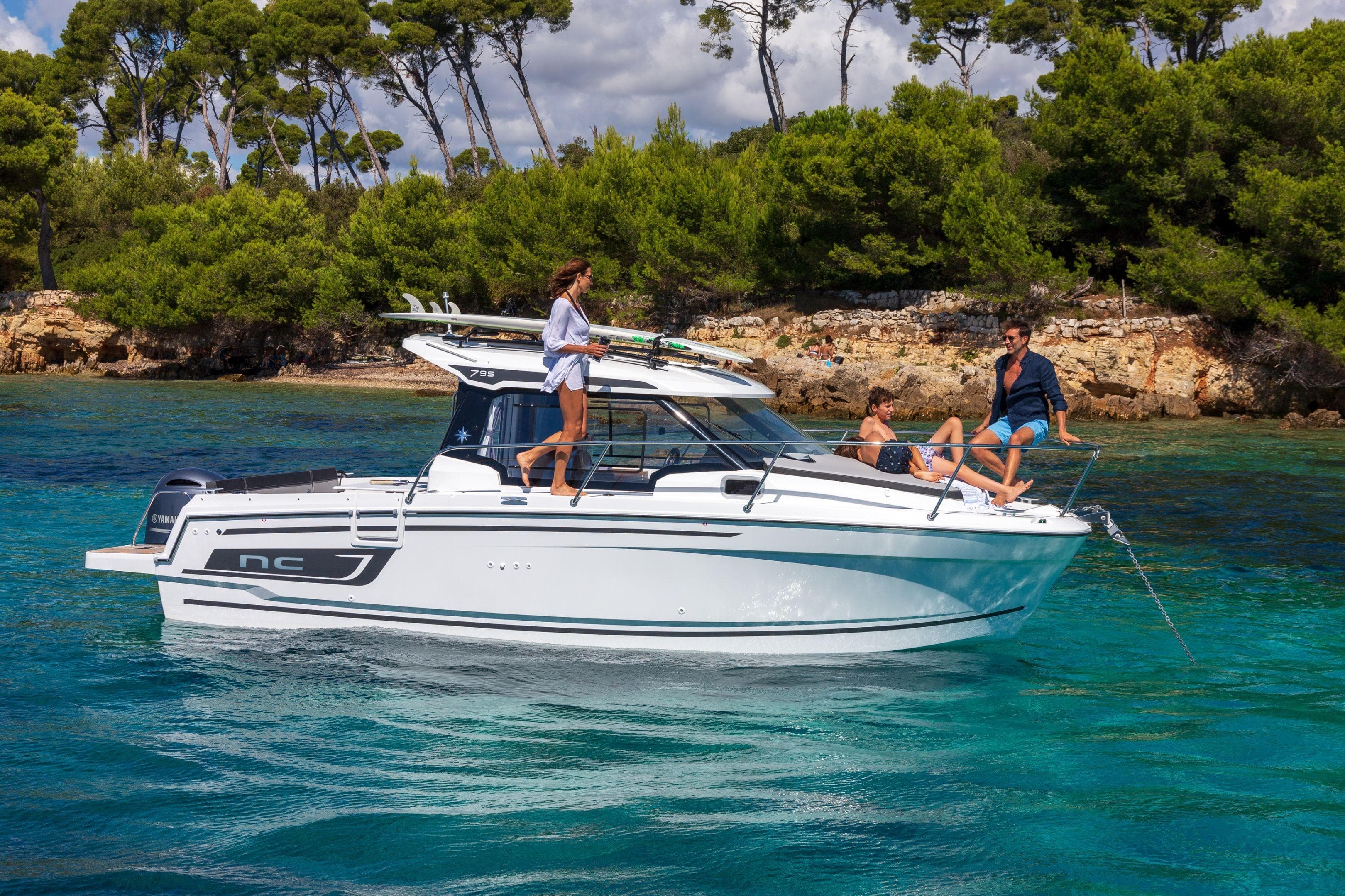 2026 Jeanneau NC 795 Series 2 boat on clear water, people relaxing onboard.