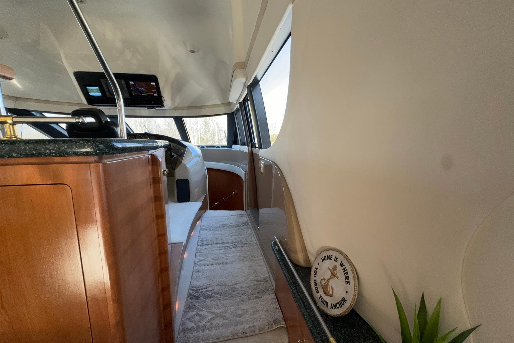 Interior of 1999 Carver 530 Voyager Pilothouse with wood accents and modern controls.