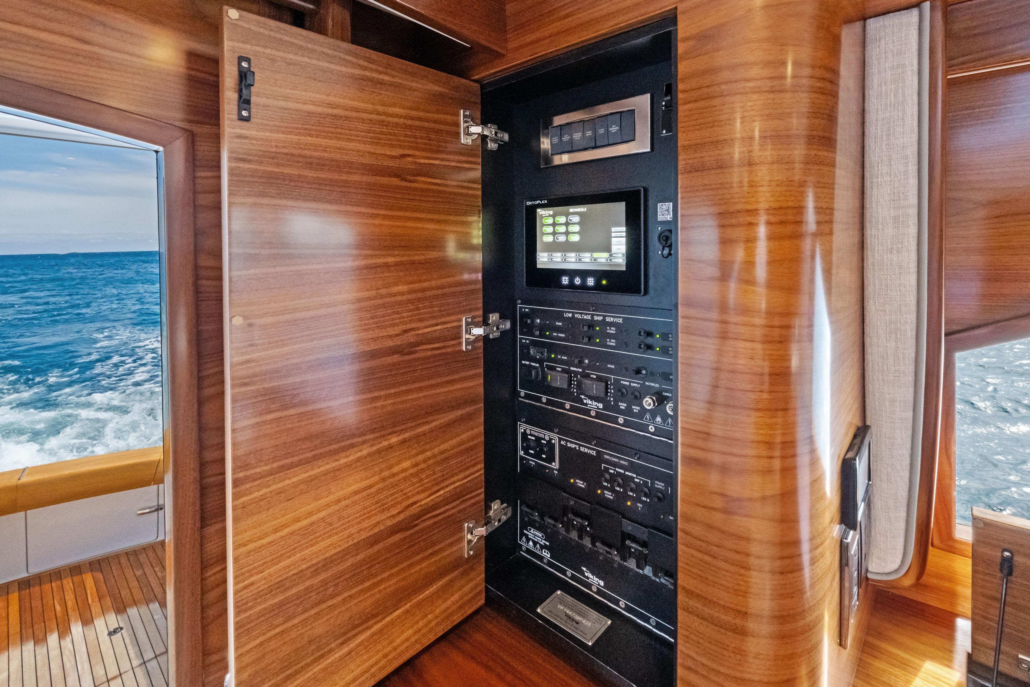 Electrical panel inside 2025 Viking 64 Convertible yacht with ocean view.