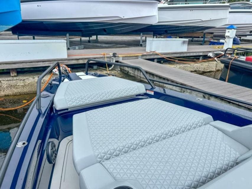 2024 BRABUS Shadow 1000 ST luxury boat docked with cushioned seating.