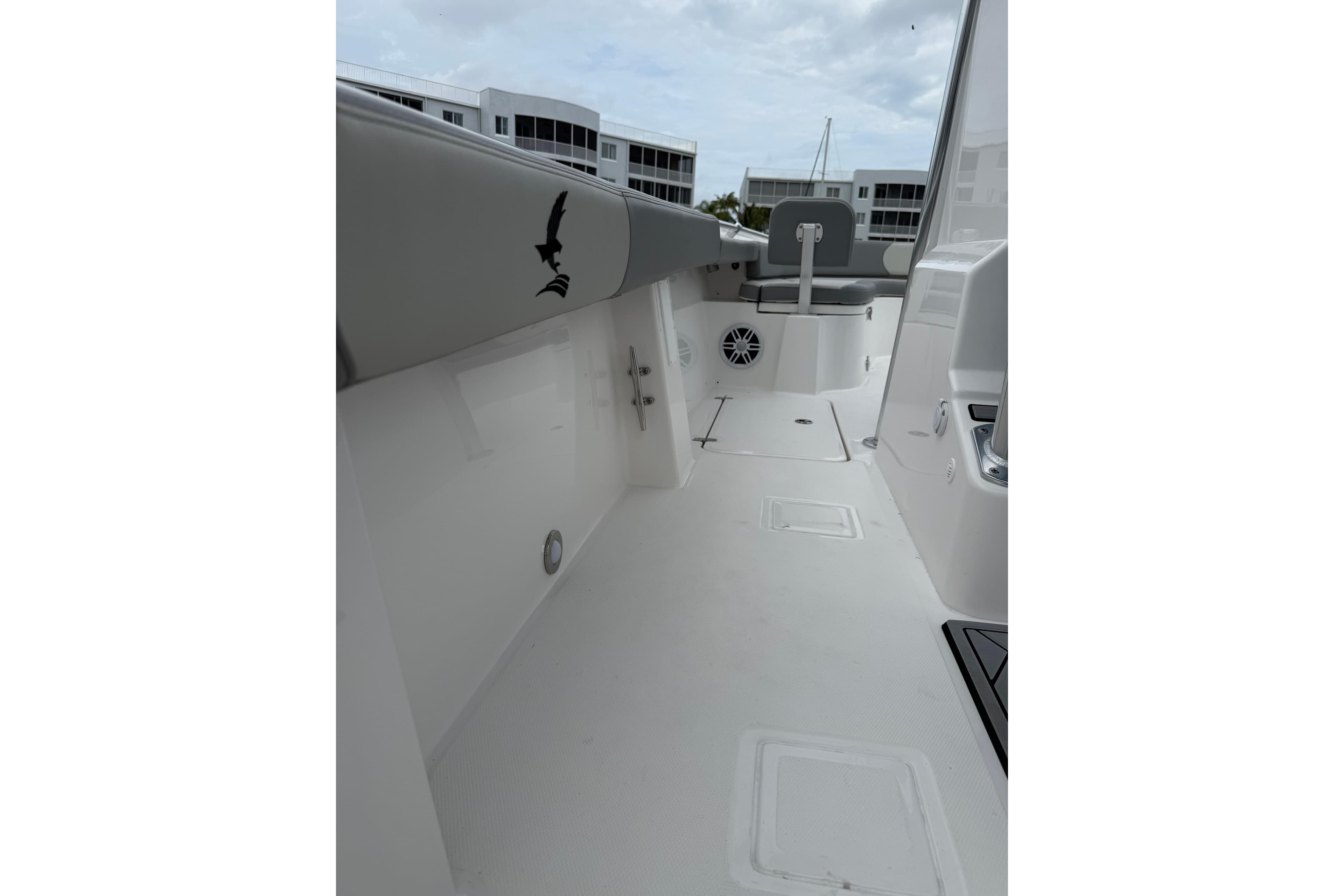 Interior view of 2026 Falcon Boats 26, featuring sleek white deck and seating.