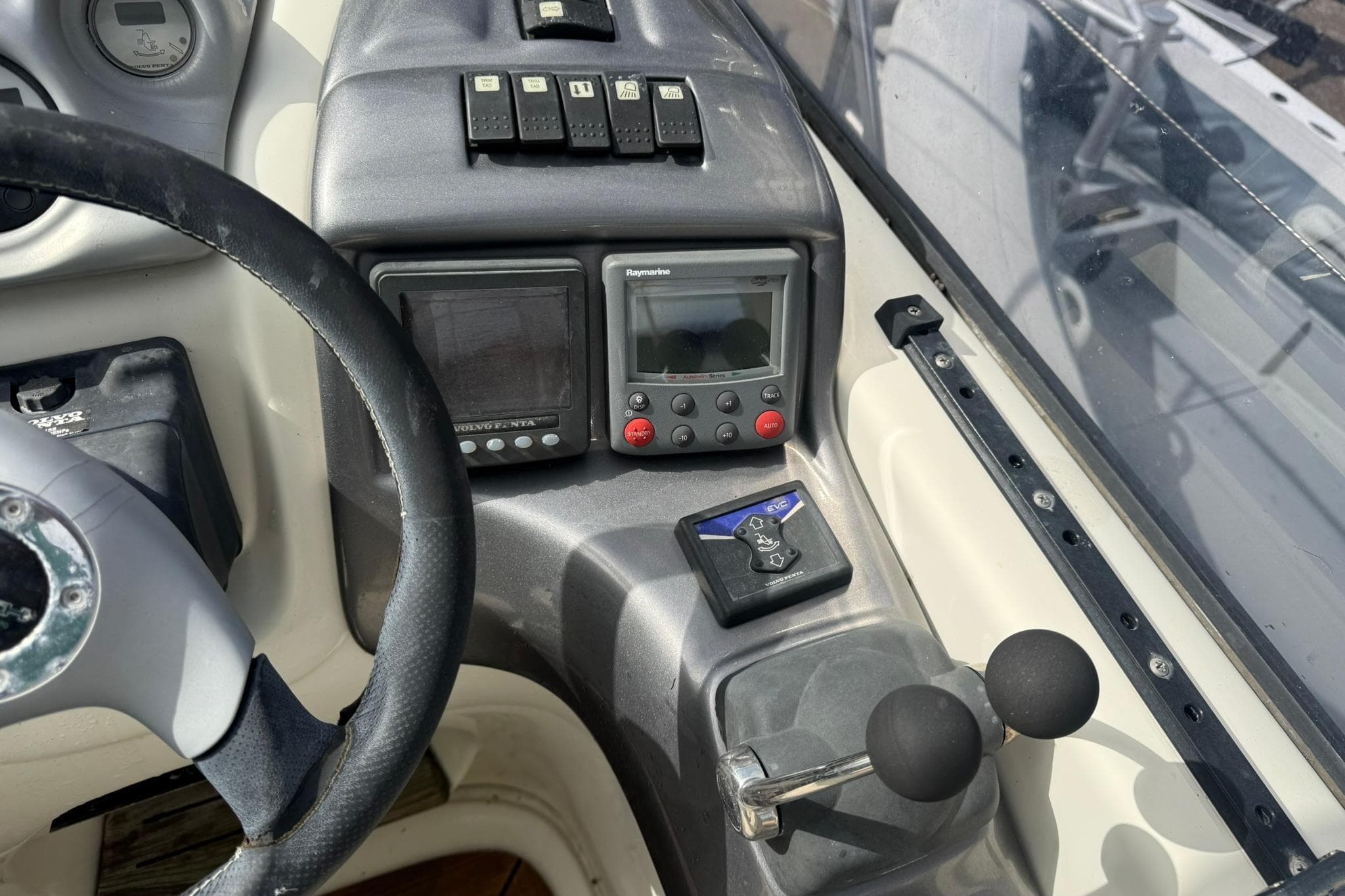 Control panel of 2009 Cranchi Endurance 41 boat with steering wheel and navigation instruments.