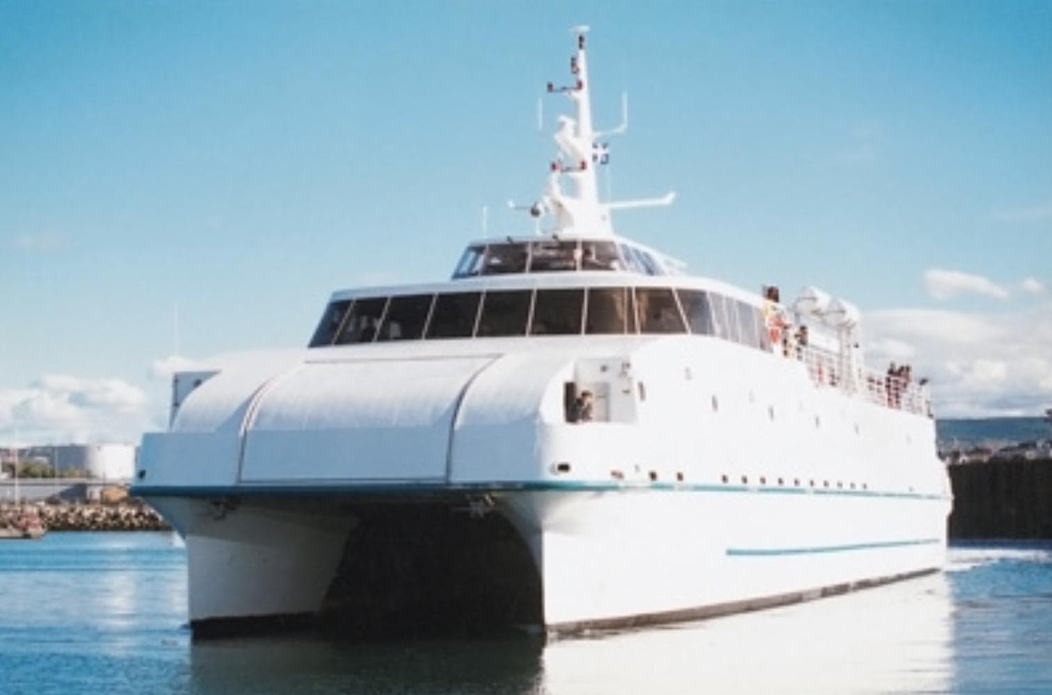 1997 CNM Evolution yacht on calm water under clear blue sky.