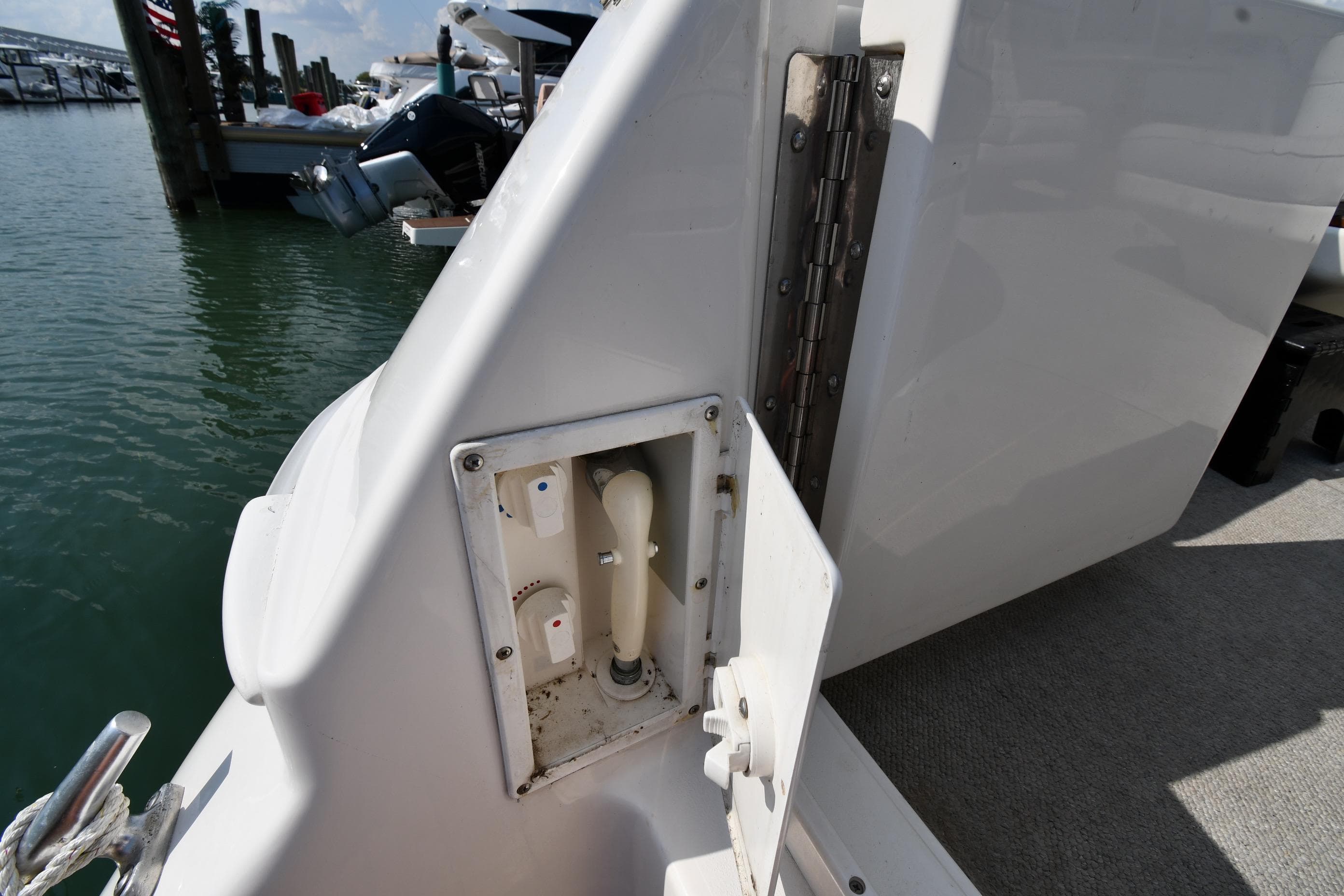 1995 Sea Ray 630 Sundancer boat deck with utility panel, docked at marina.