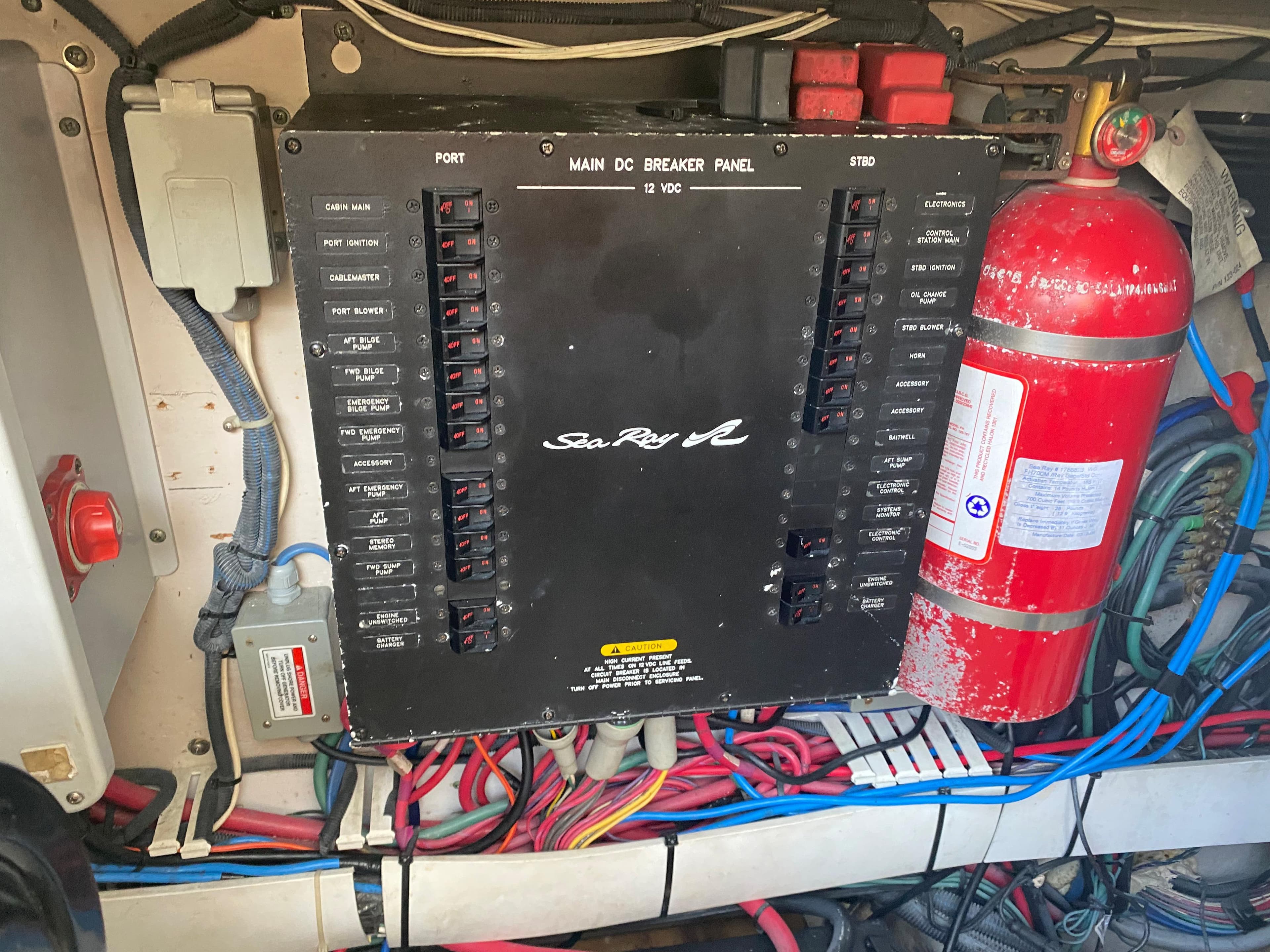 Main DC breaker panel on 2006 Sea Ray 48 Sundancer, with wiring and fire extinguisher.
