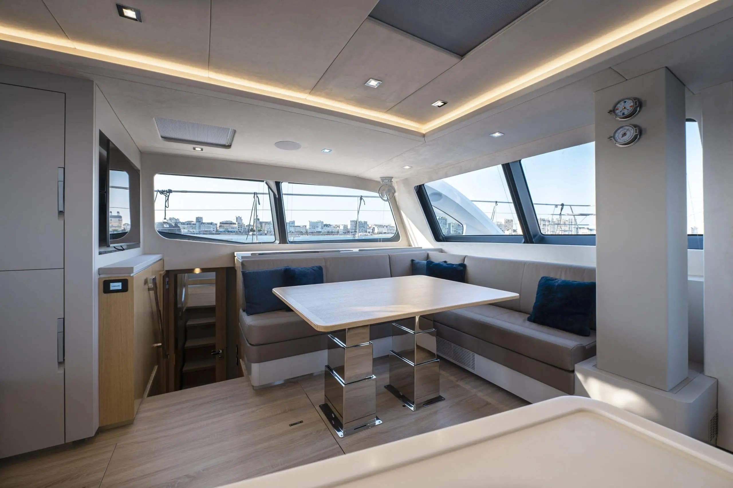 Luxurious interior of 2027 Privilege Signature 580 yacht with modern seating and panoramic windows.