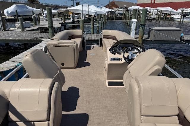2019 Sun Tracker Party Barge 24 DLX pontoon boat docked at marina.