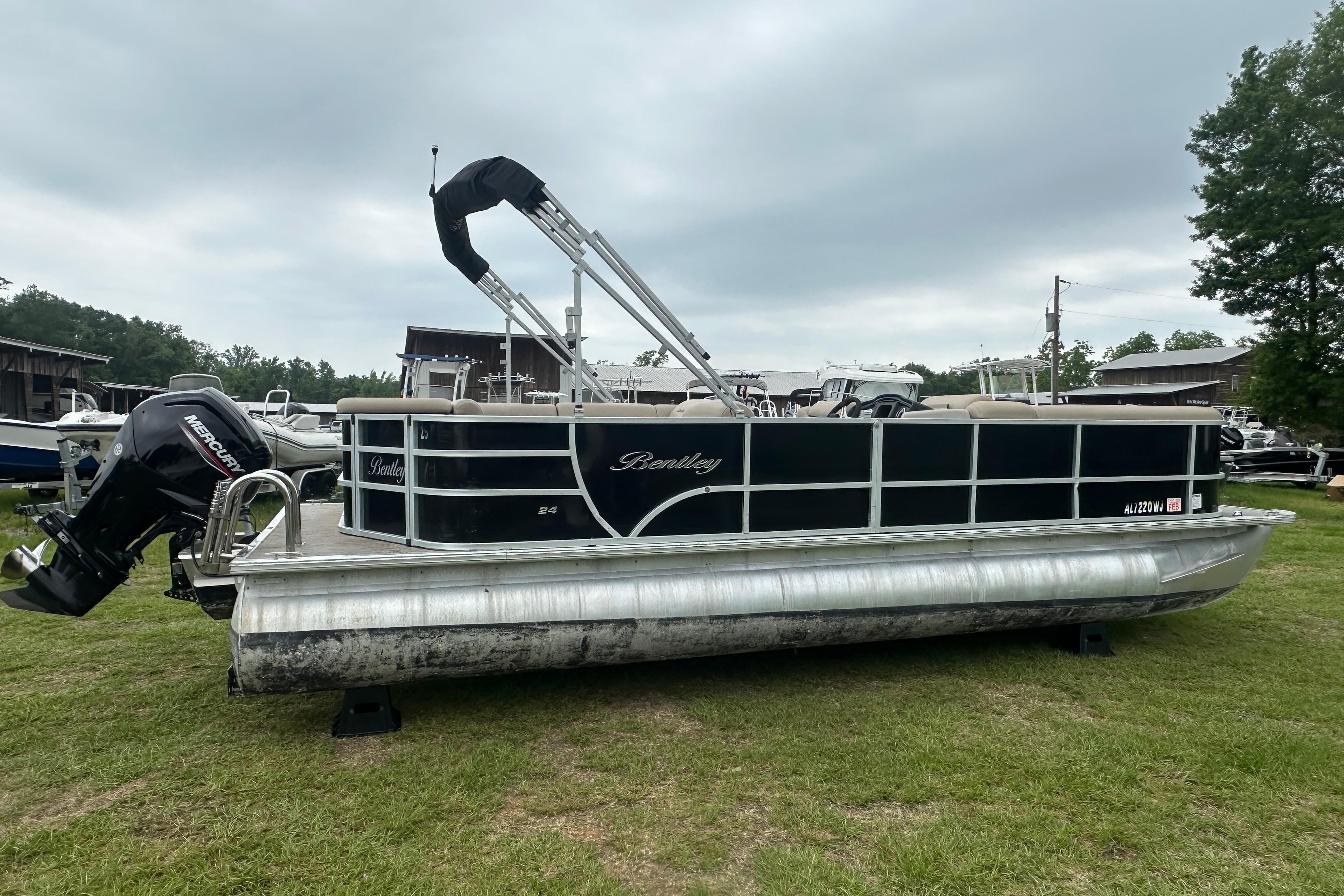 2021 Bentley Pontoons 240 CRUISE pontoon boat on grass with Mercury outboard motor.