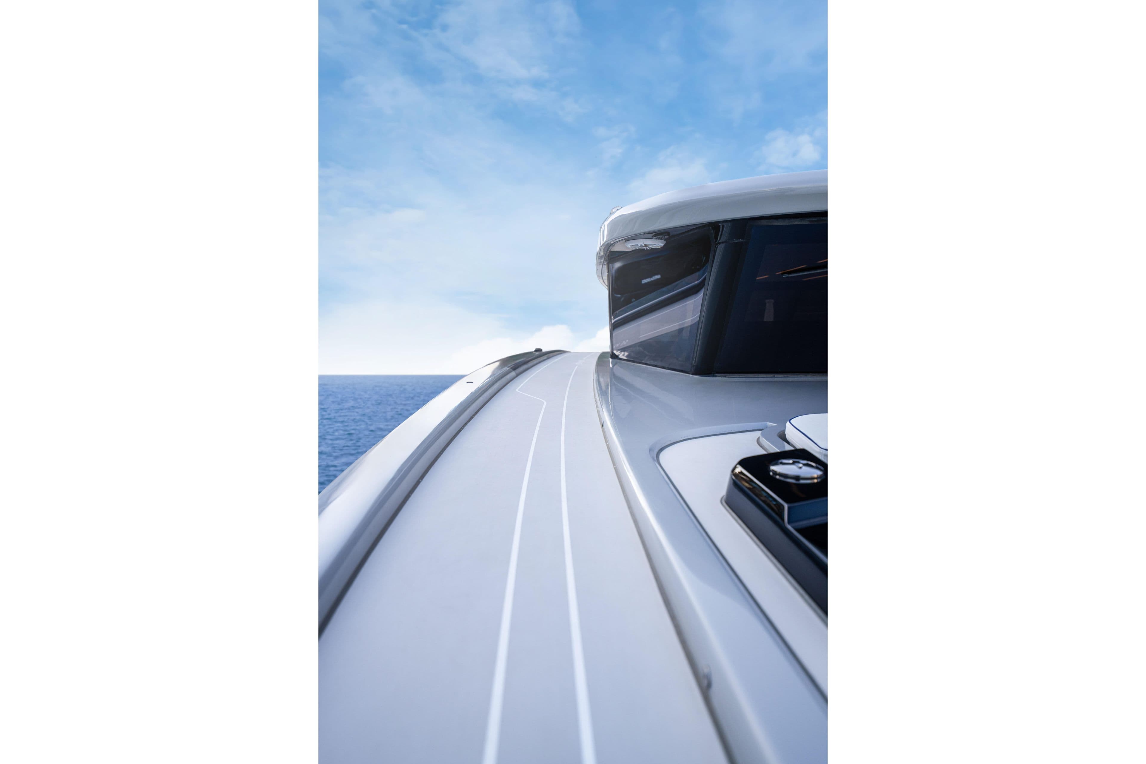 2025 Sunreef 55 ULTIMA yacht, sleek design, cruising on open sea under clear blue sky.