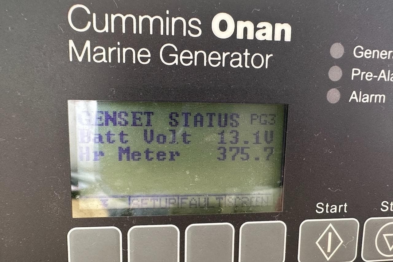 Cummins Onan marine generator display showing battery voltage and hour meter on Lagoon 46, 2023.