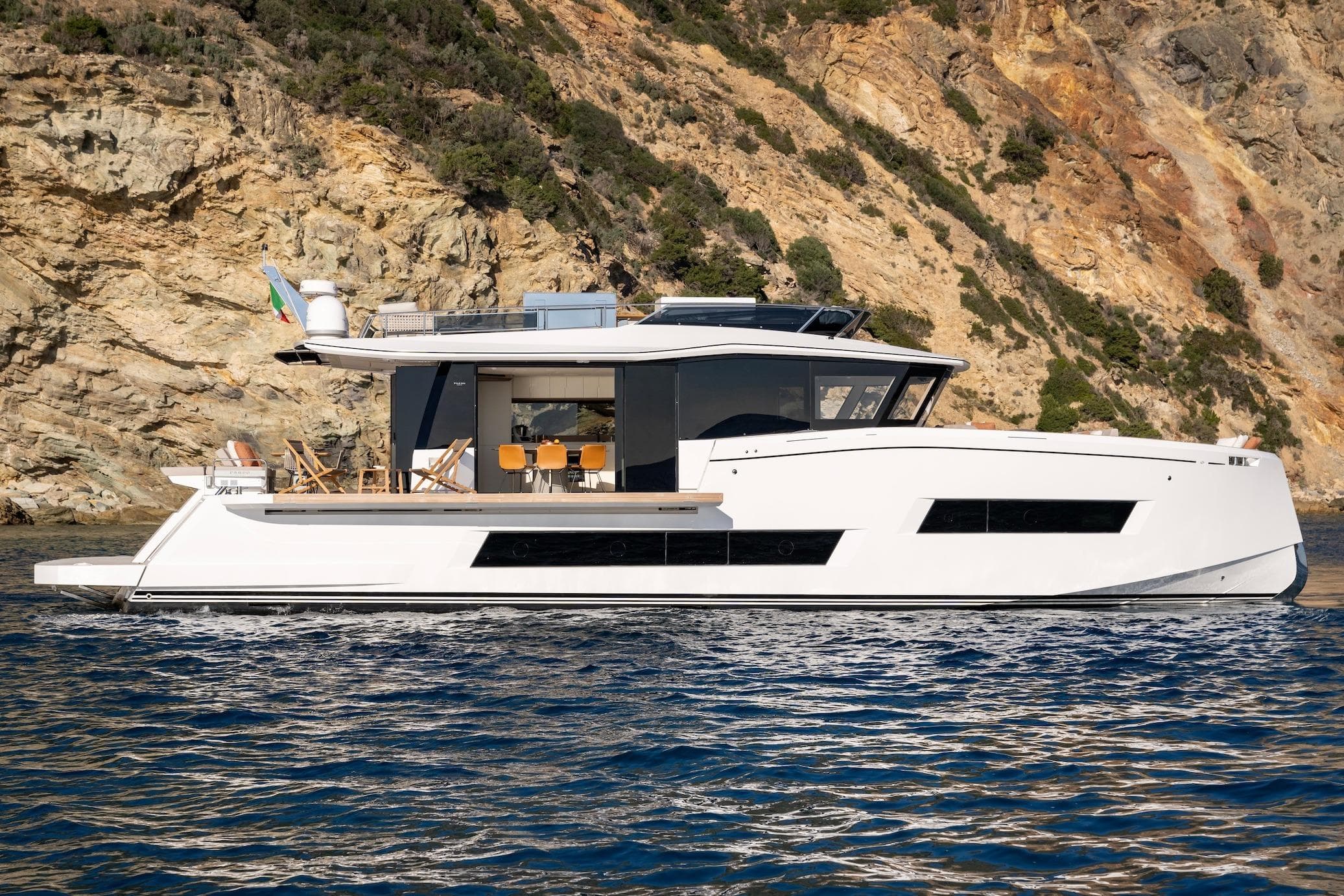 2026 Pardo Yachts E72 luxury yacht cruising near rocky coastline.
