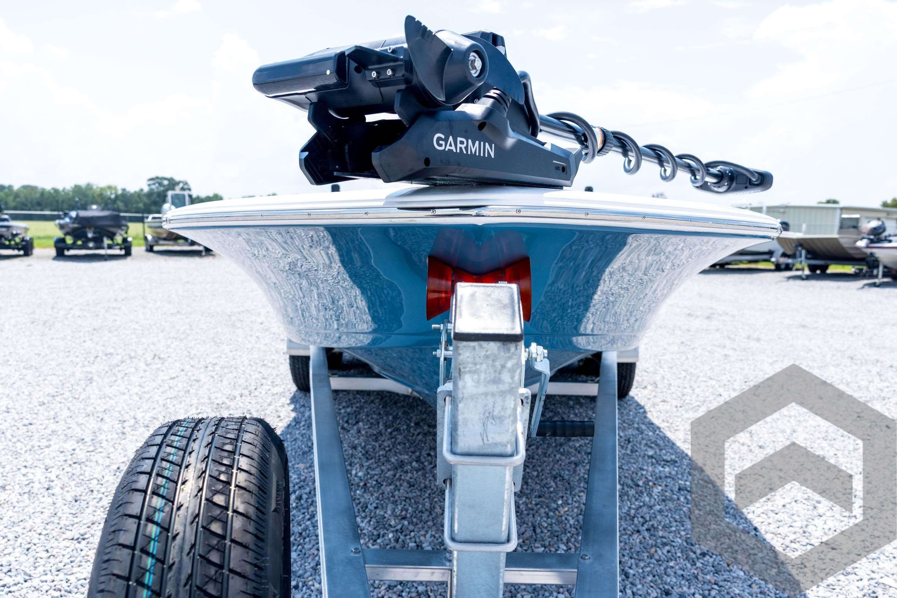 2026 Tidewater 2110 Bay Max boat on trailer with Garmin equipment, parked on gravel.