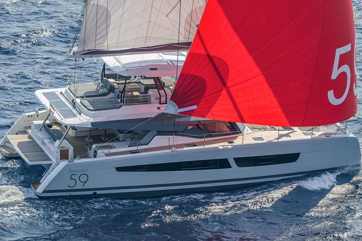 2026 Fountaine Pajot Samana 59 catamaran sailing with red sail on open sea.