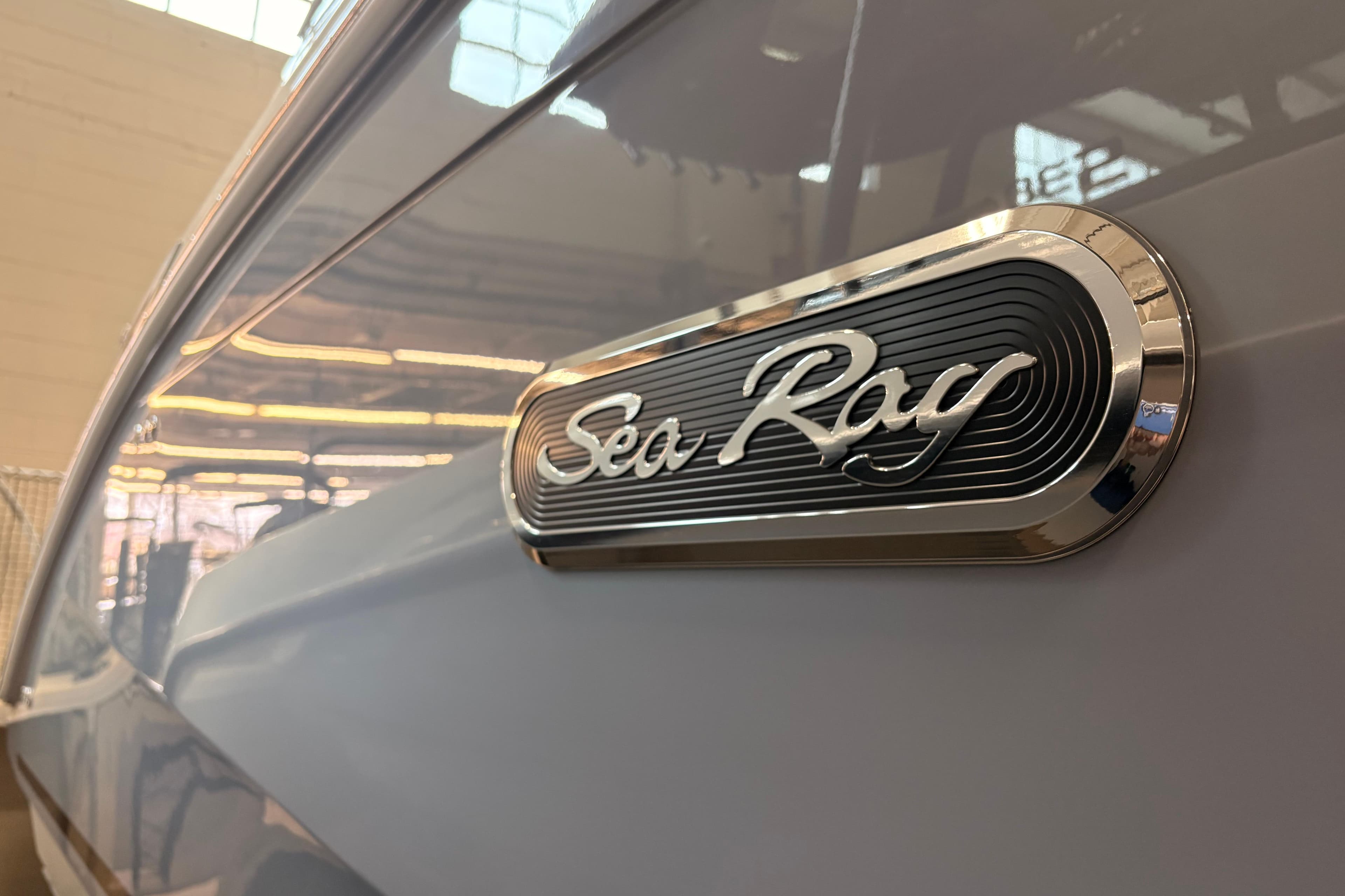 2026 Sea Ray Sundancer 320 emblem on sleek boat exterior.