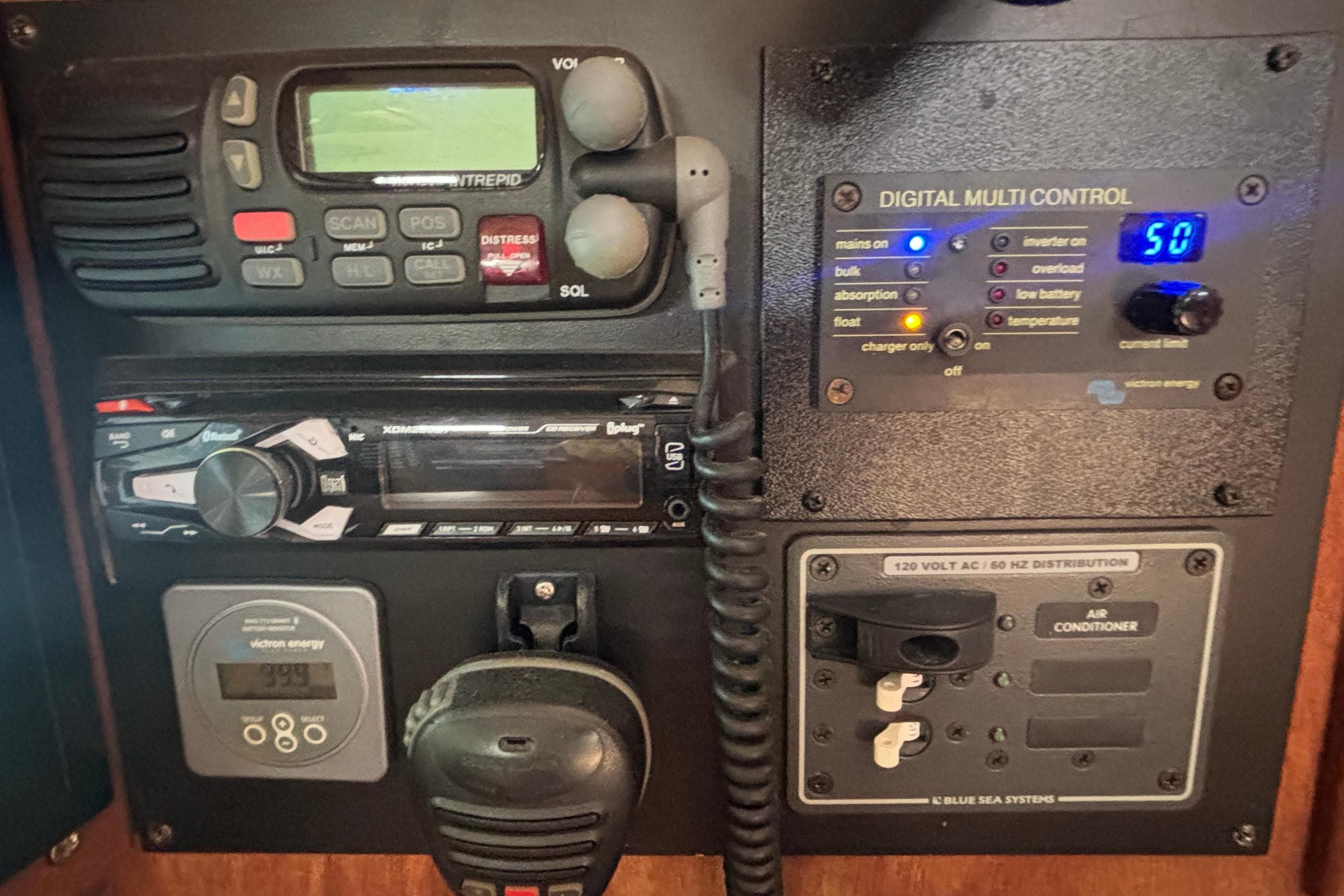 Control panel of a 2002 Island Packet 380 sailboat with radio and digital controls.