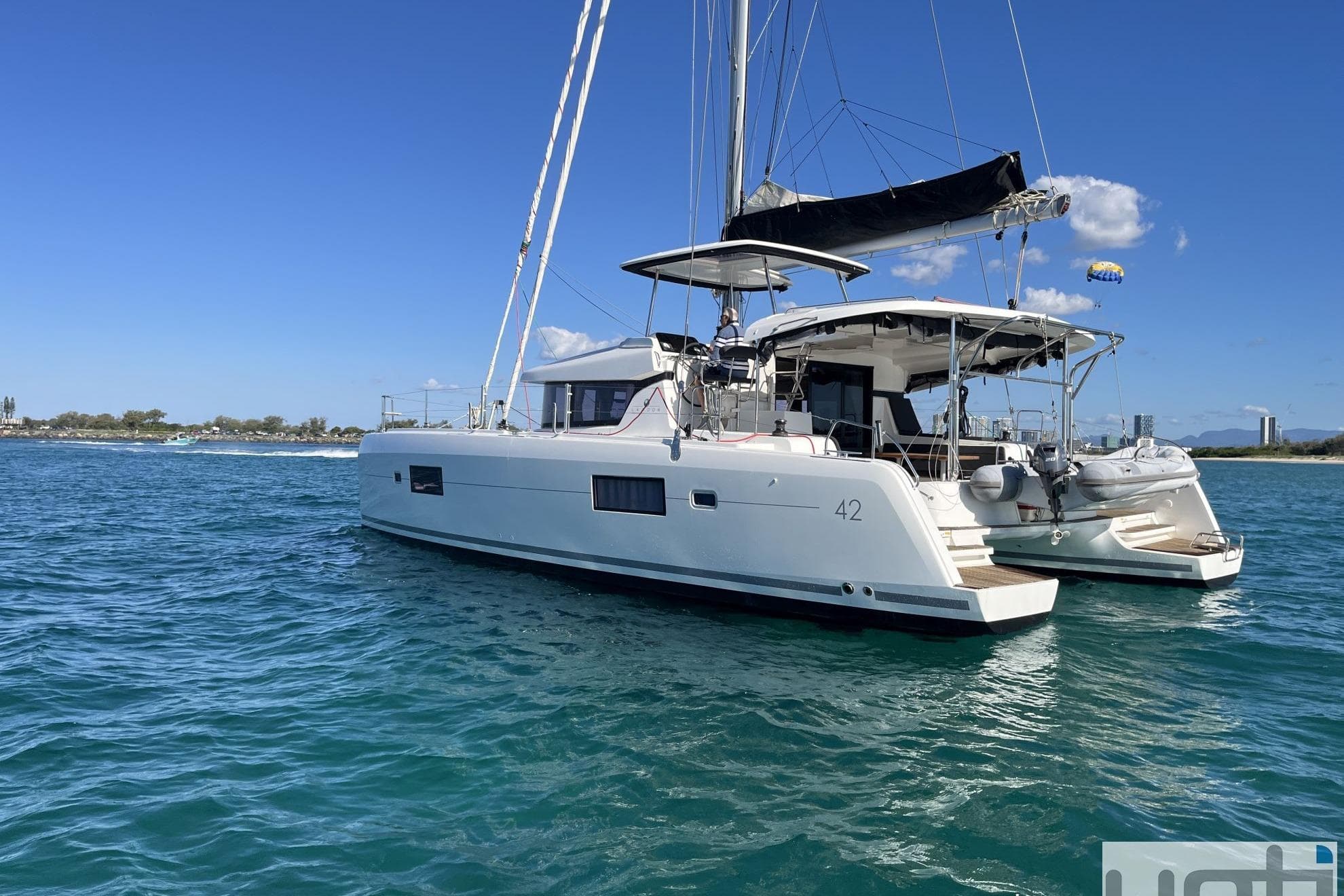 2017 Lagoon 42 catamaran sailing on clear blue waters under a sunny sky.