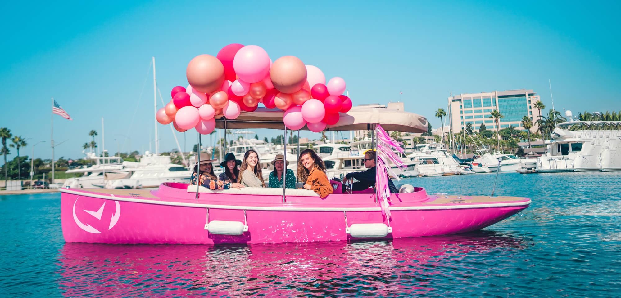 Pink Vision Marine Fantail 217 boat with balloons, cruising in a marina, 2023 model.