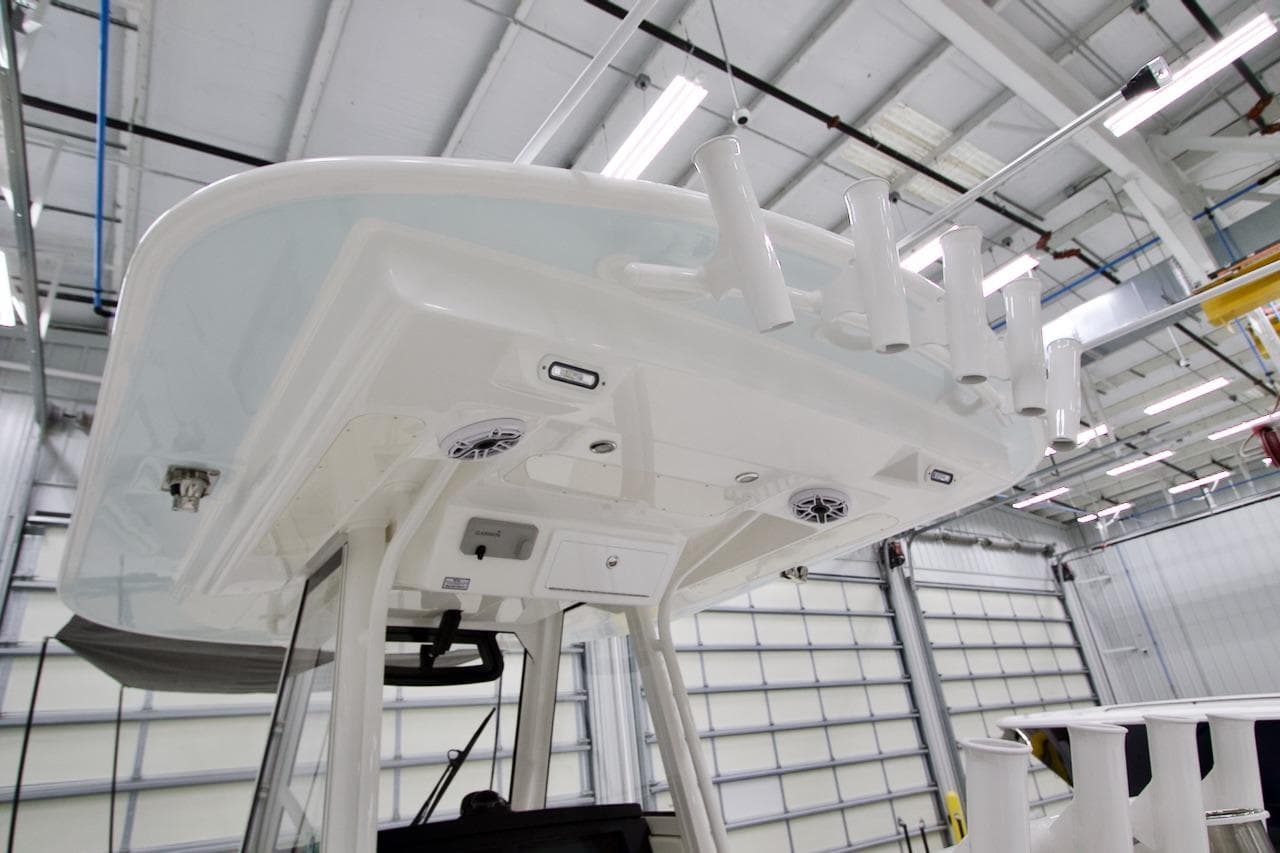2026 Regulator 31 boat interior with rod holders and speakers in a modern facility.