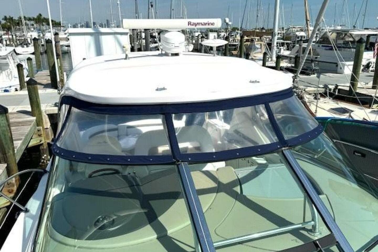 2003 Sea Ray 420 Sundancer yacht docked at a marina, featuring a sleek design.