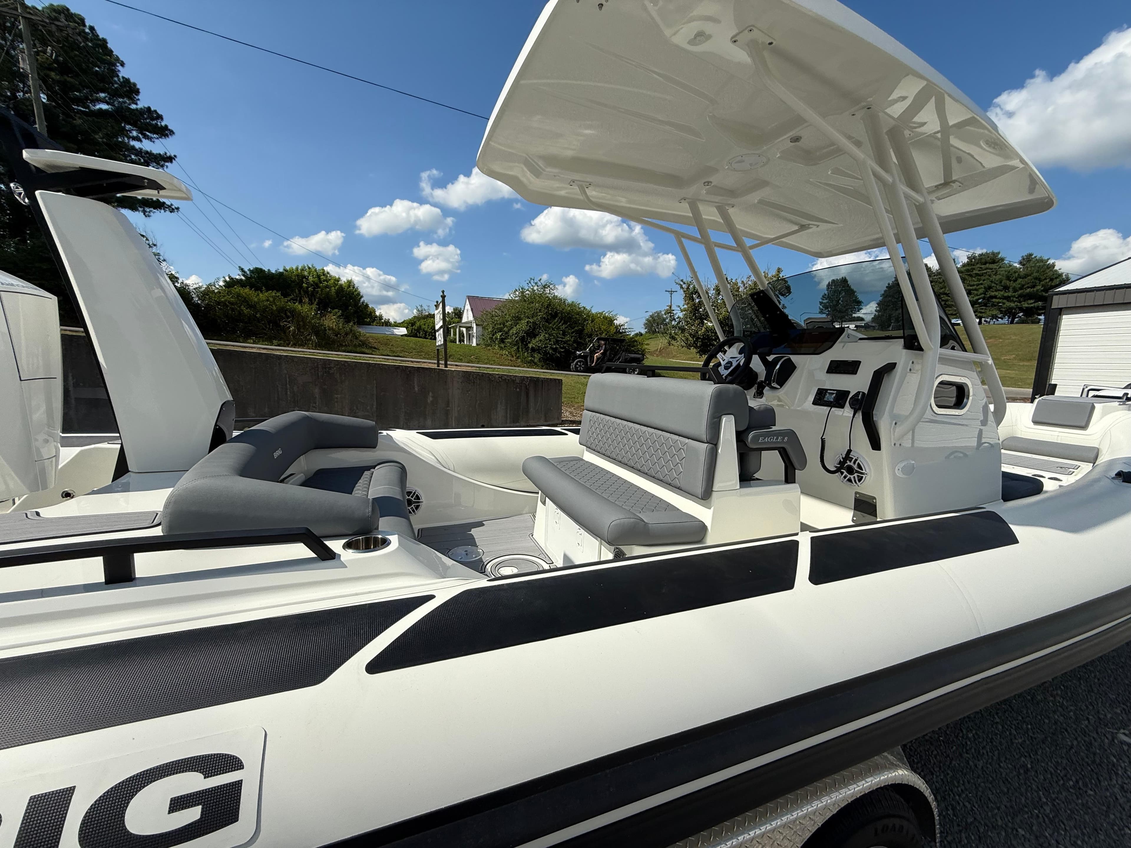 2026 Brig Eagle 8 boat with seating and console, under a clear blue sky.