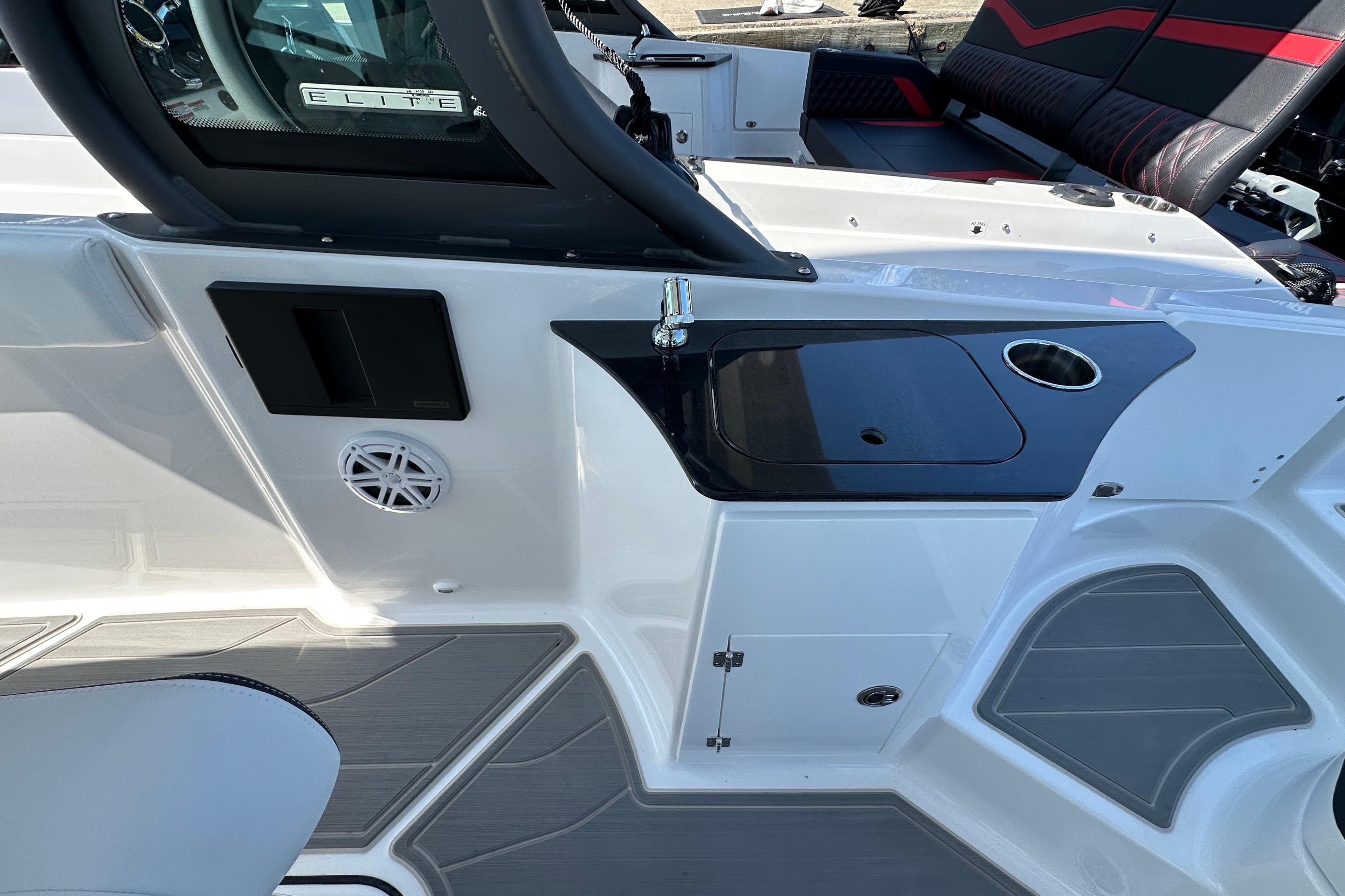 2026 Monterey Elite 25 OB boat interior with sink, cup holder, and seating area.