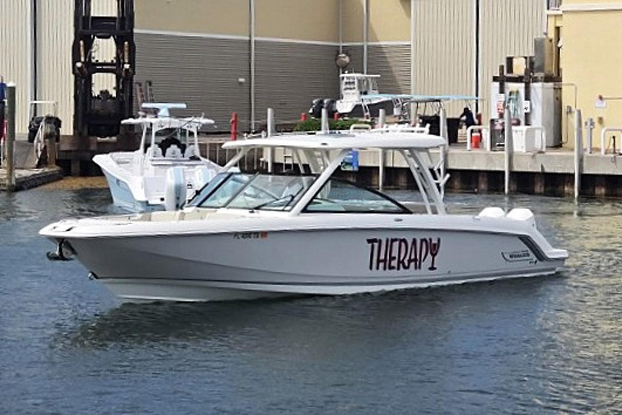 2022 Boston Whaler 320 Vantage boat named "Therapy" docked at a marina.