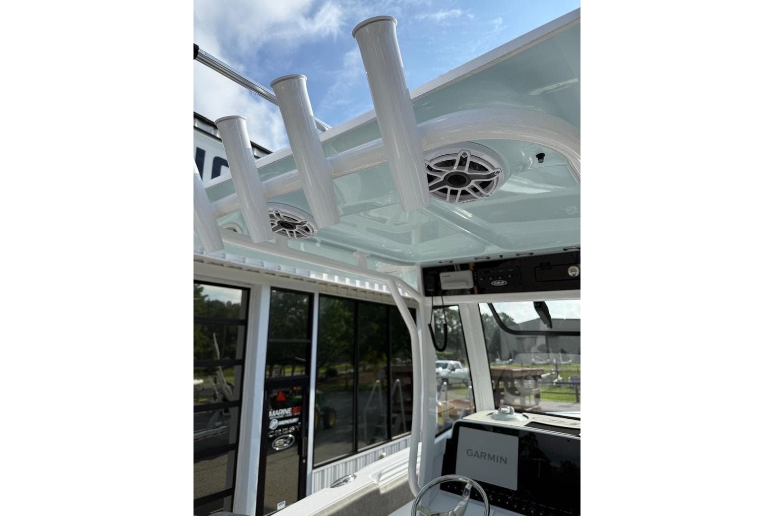 Interior view of 2026 Sea Hunt Ultra 255 SE boat with rod holders and speakers.
