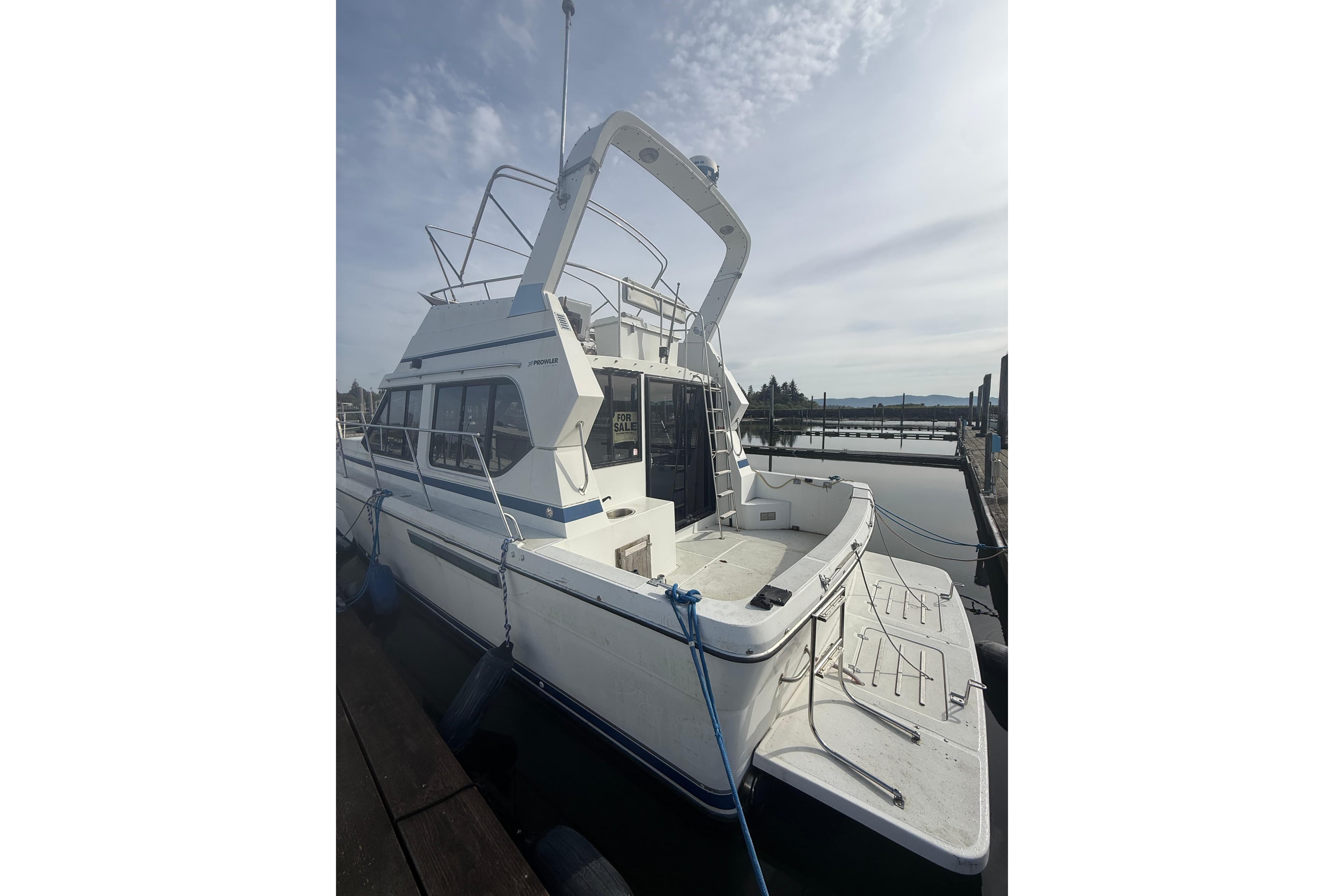 1990 Cooper Prowler boat docked, white exterior, for sale sign visible.