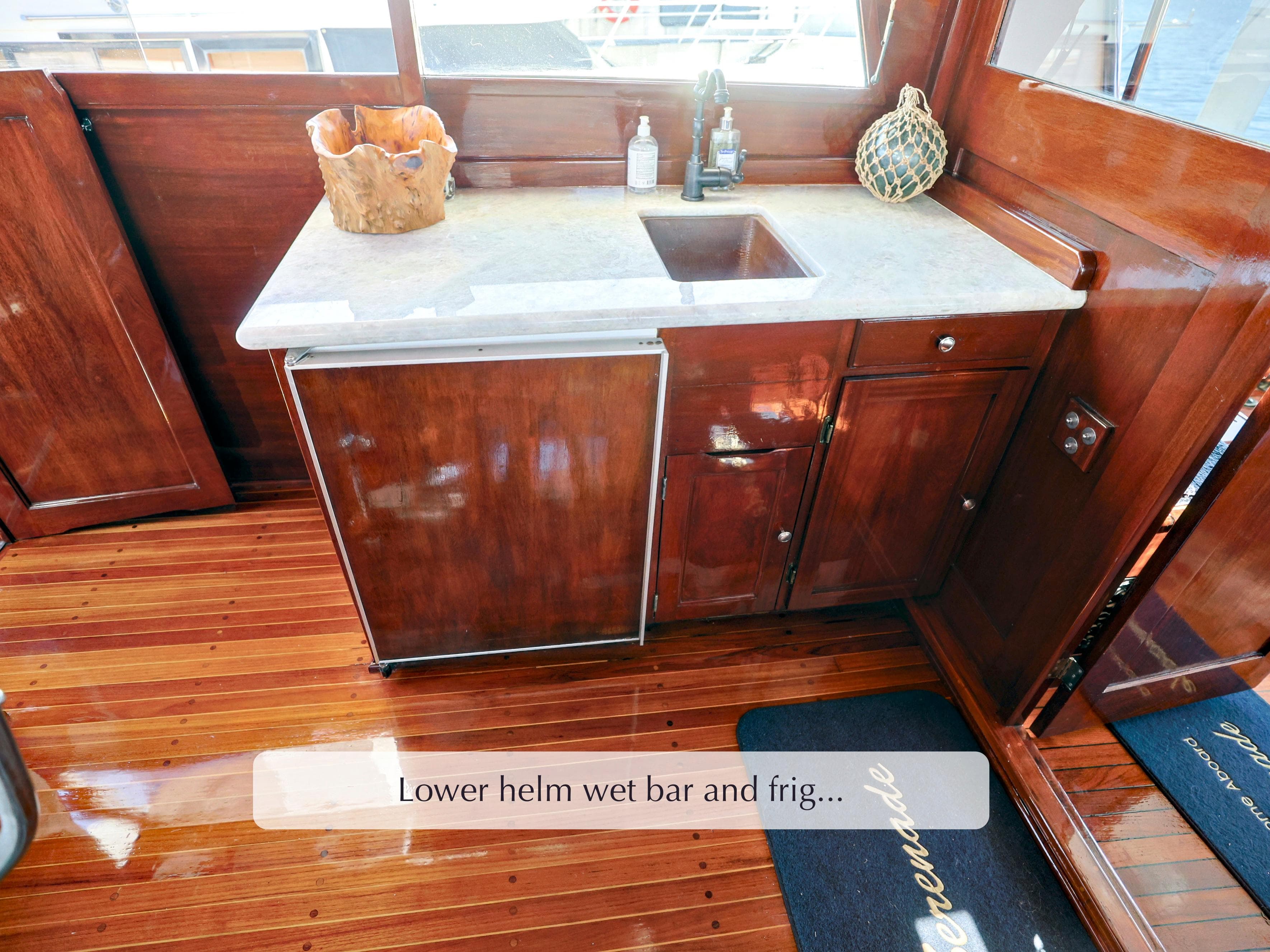 Lower helm wet bar with sink and fridge on 1968 Stephens Motor Yacht.