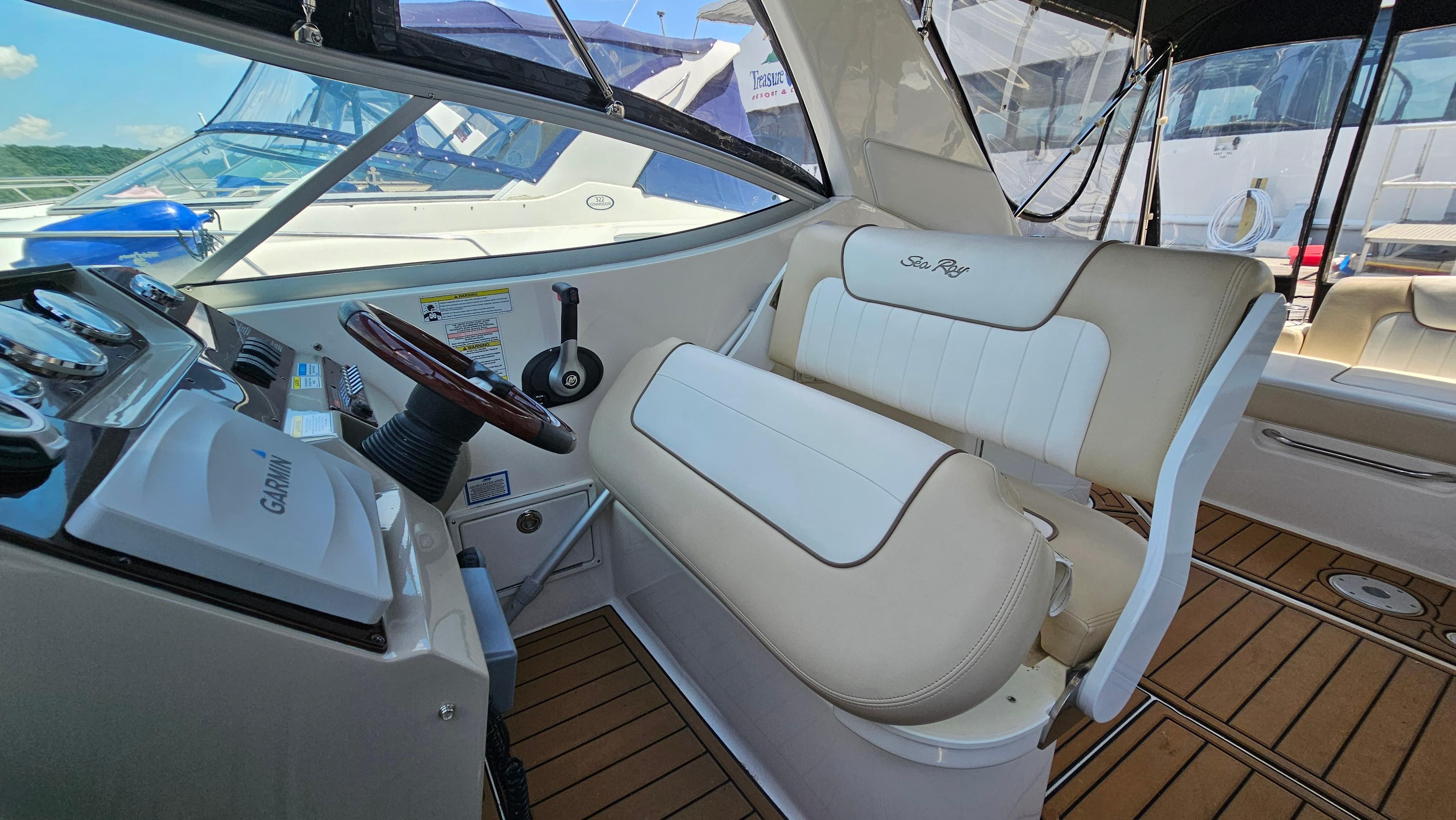 2013 Sea Ray 280 Sundancer helm with Garmin navigation and plush seating.