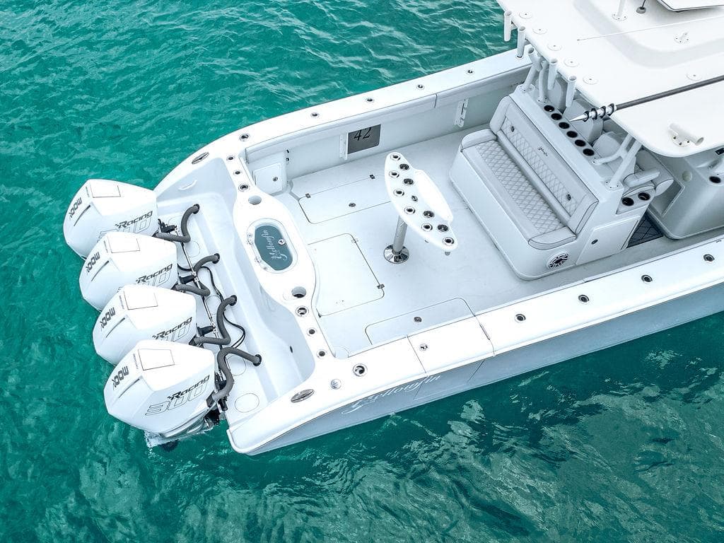 2019 Yellowfin 42 boat with triple outboard engines on turquoise water.