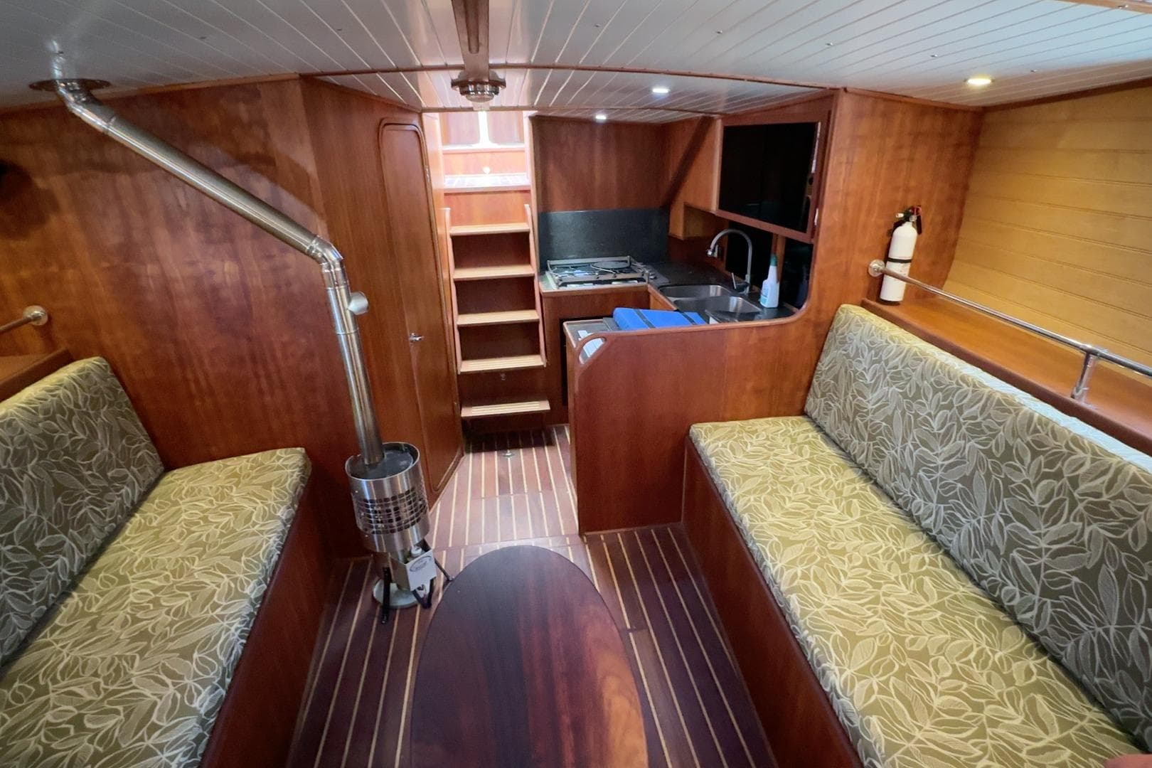 Luxurious interior of 2012 Custom Pacific Northwest 43 yacht with wood finish and cozy seating.