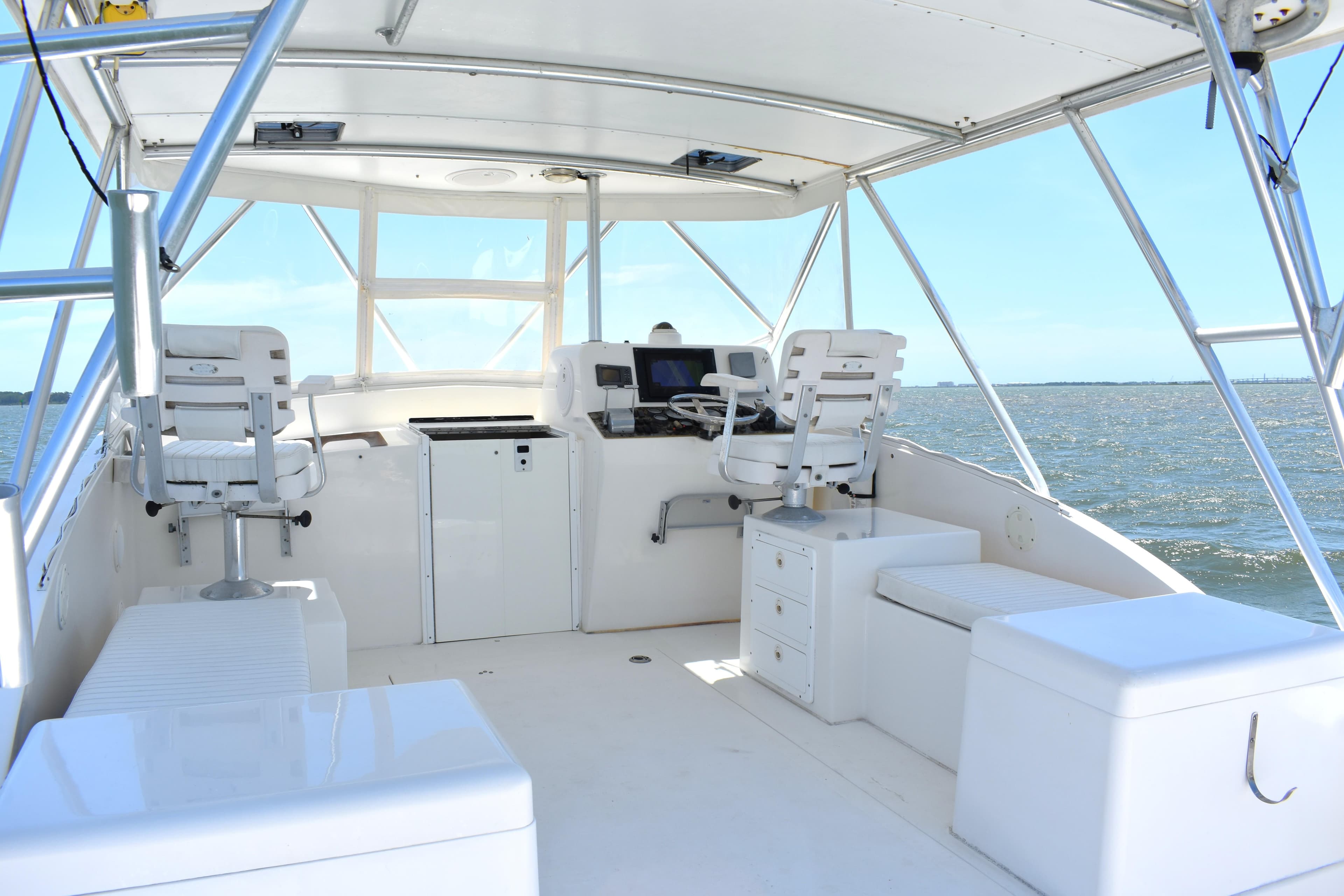 2004 Judge 34 Express boat interior with helm, seating, and ocean view.