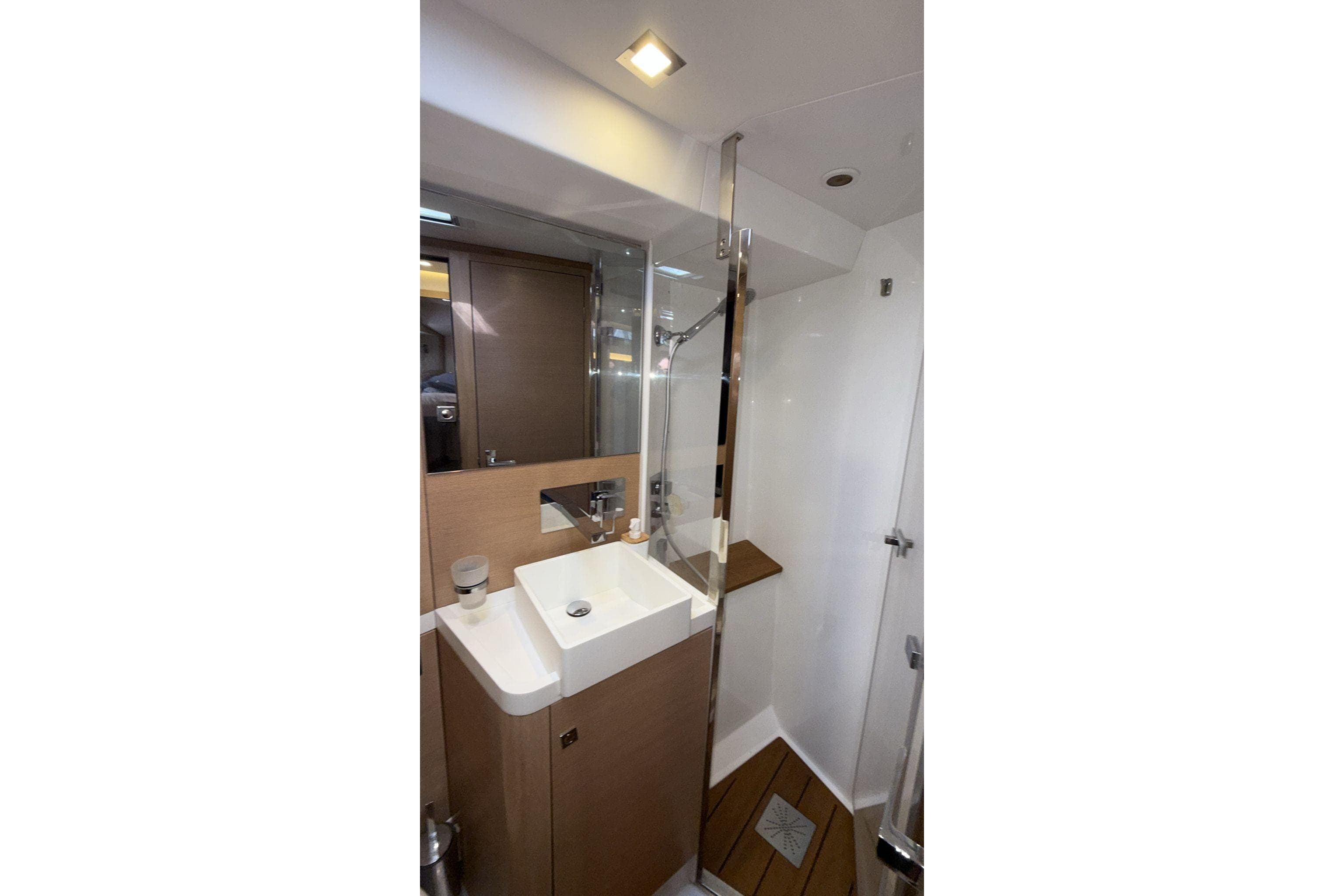 Modern bathroom interior on 2019 Amel 50 yacht, featuring sleek sink and shower.