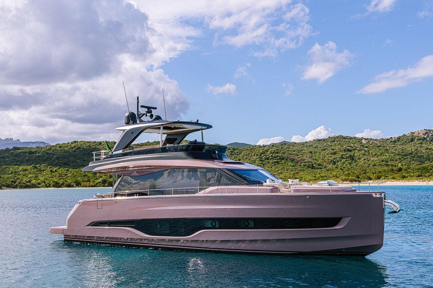 2026 Cranchi Sessantadue 62 yacht on serene water with lush green hills.