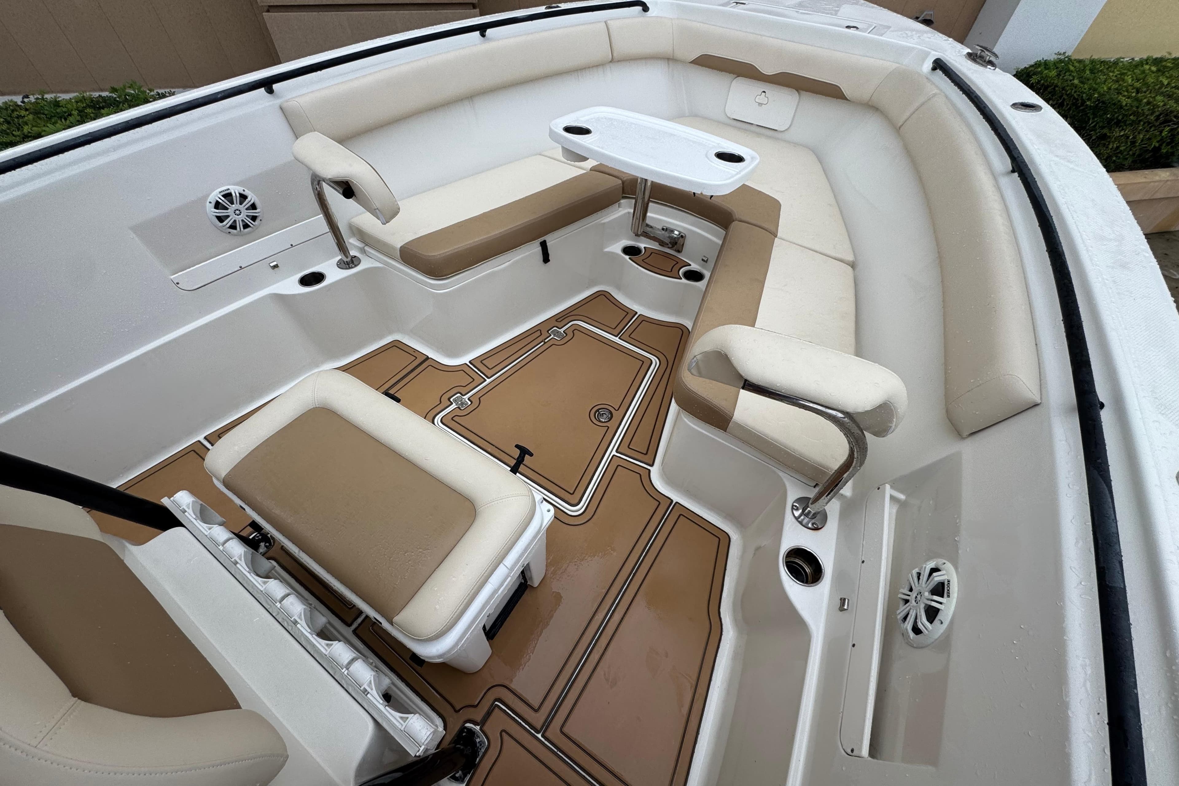 2015 Sailfish 320 CC boat interior with beige seating and a small table.