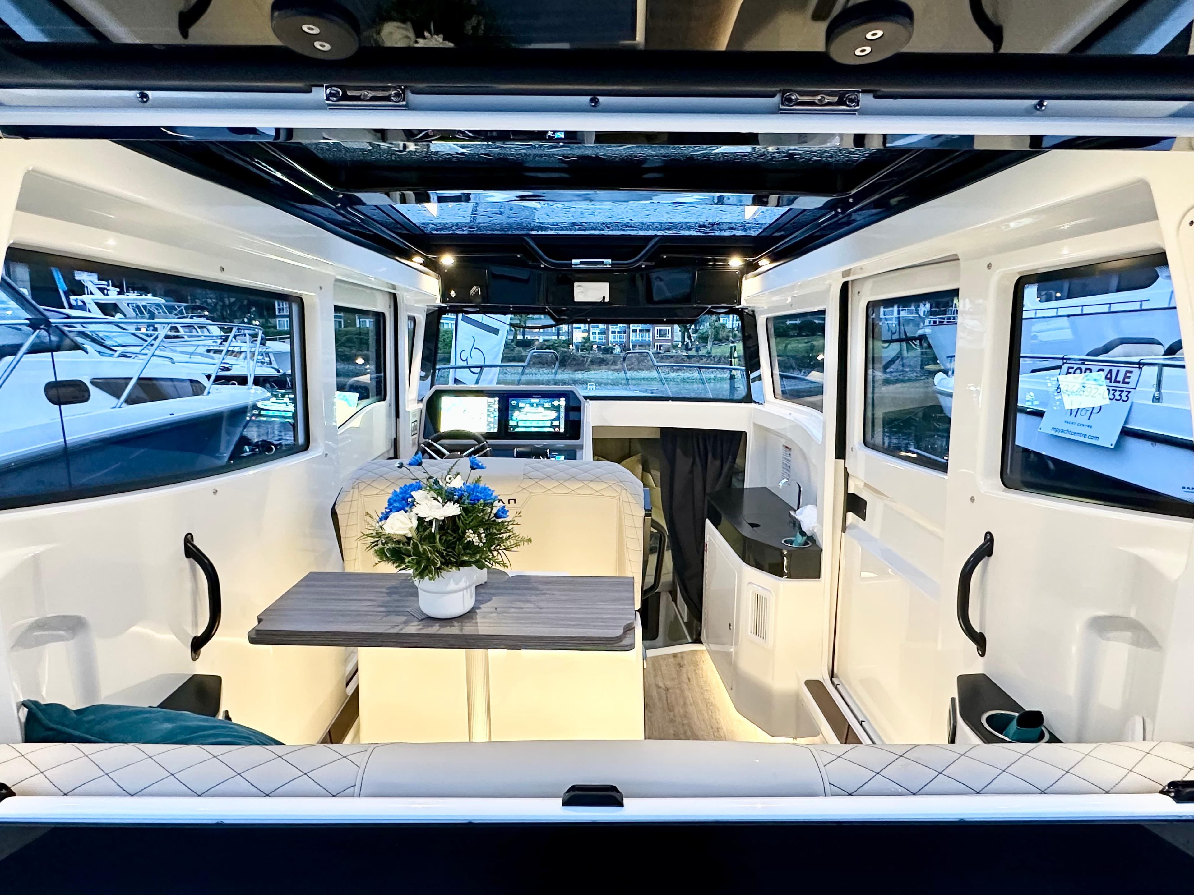 Interior of 2025 Navan C30 boat with modern design and floral centerpiece.
