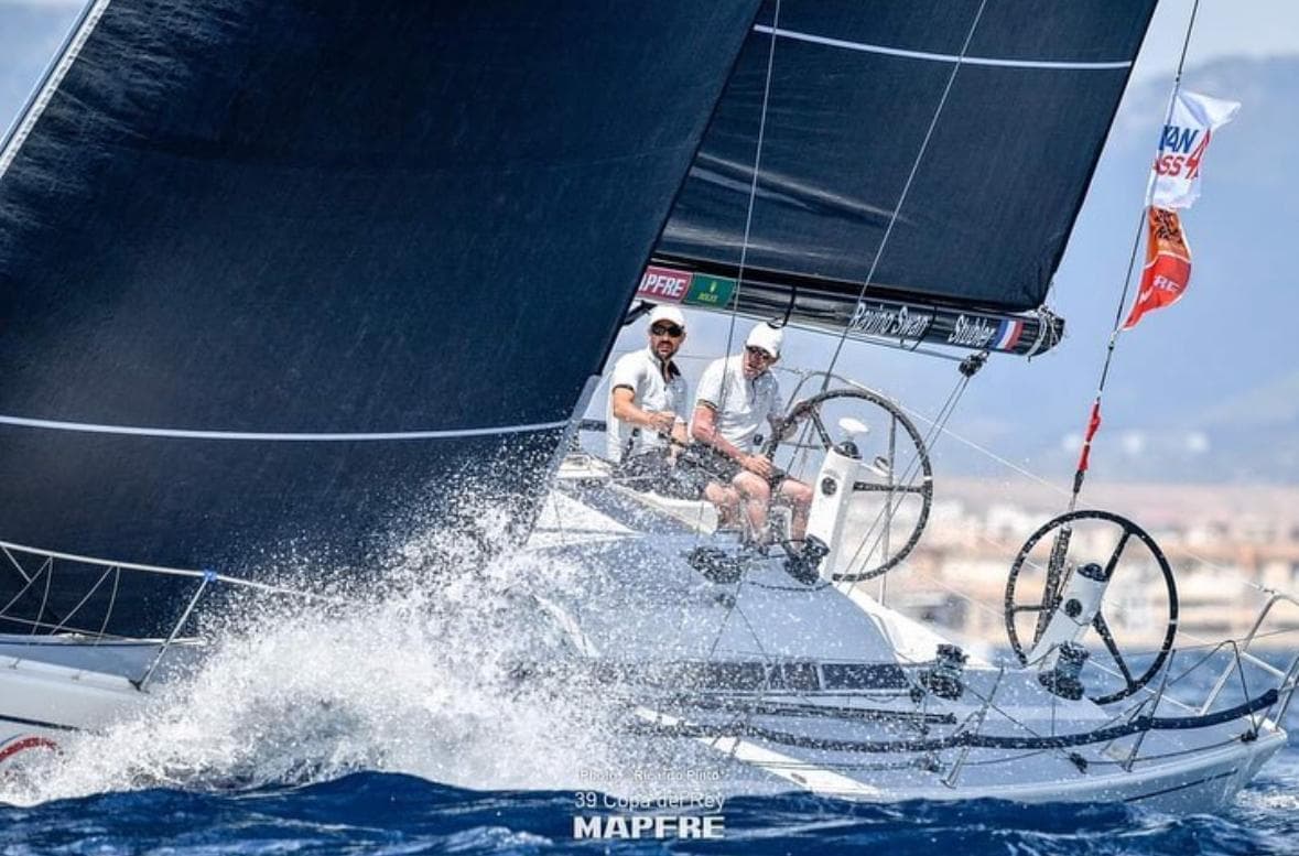 Sailing race with Nautor Swan ClubSwan 42, 2006 model, cutting through waves.
