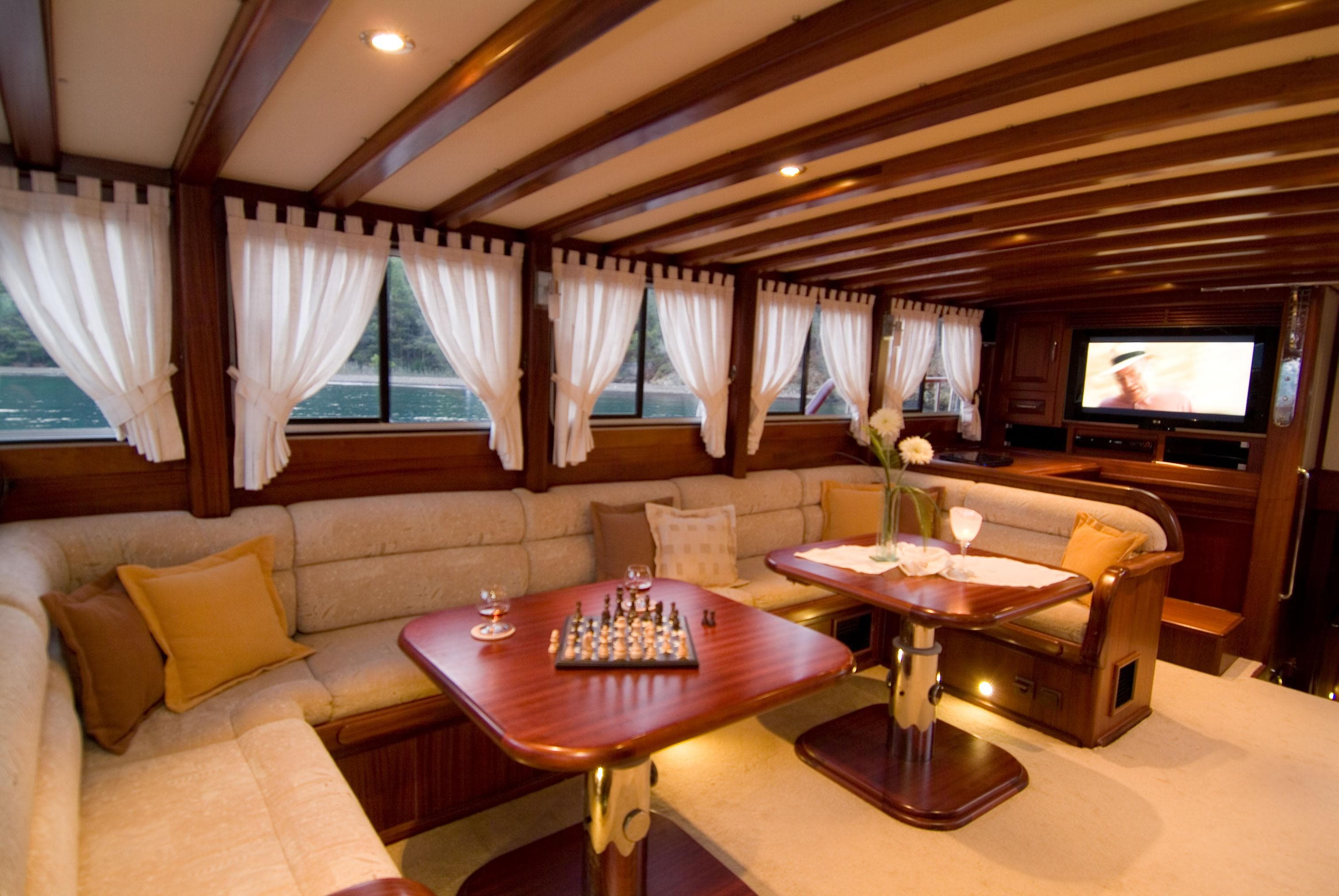 Luxurious interior of 2006 Custom Gulet Ketch with elegant seating and chessboard.