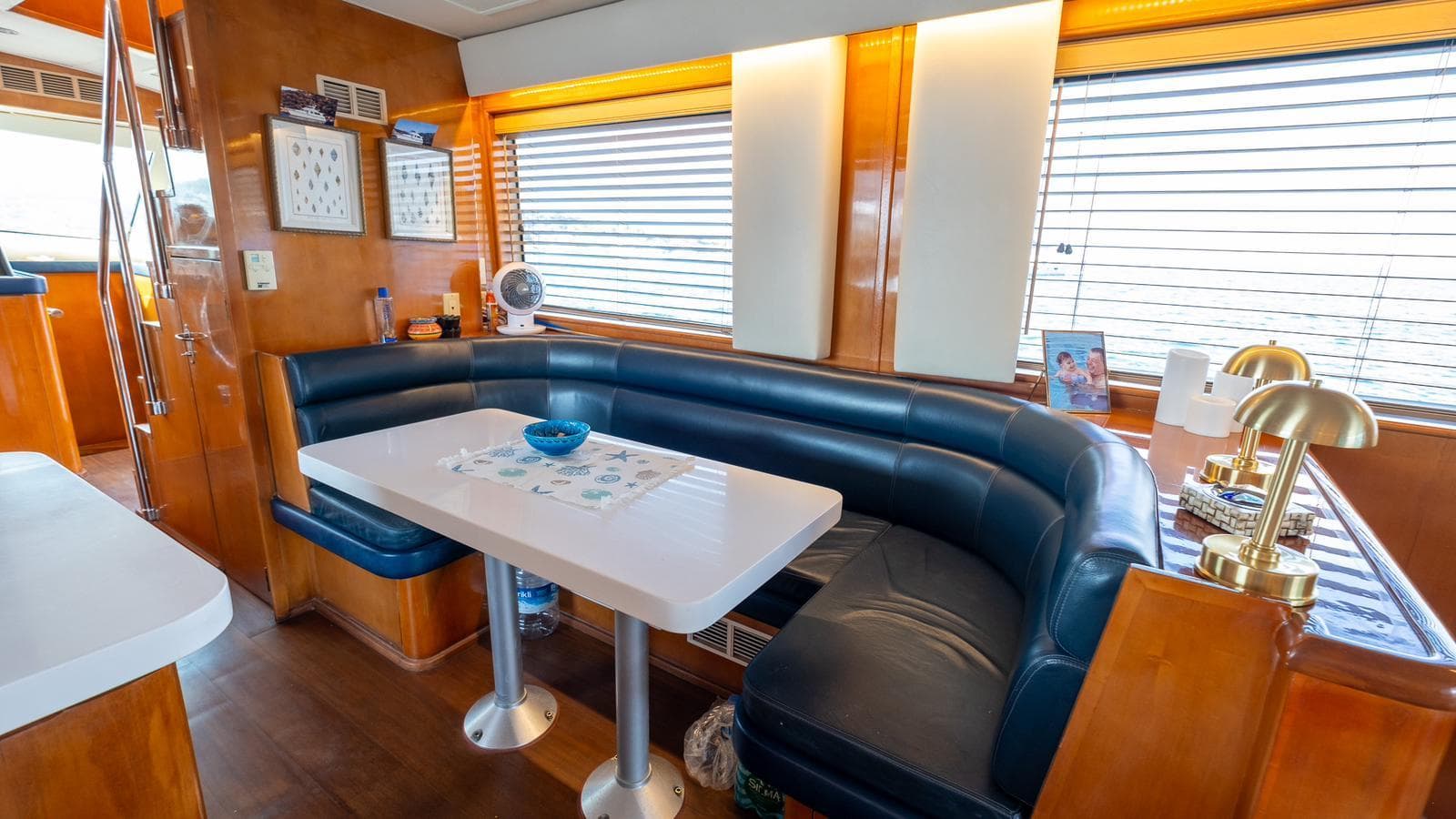 Luxurious 1997 Hatteras 70 yacht interior with elegant seating and dining area.