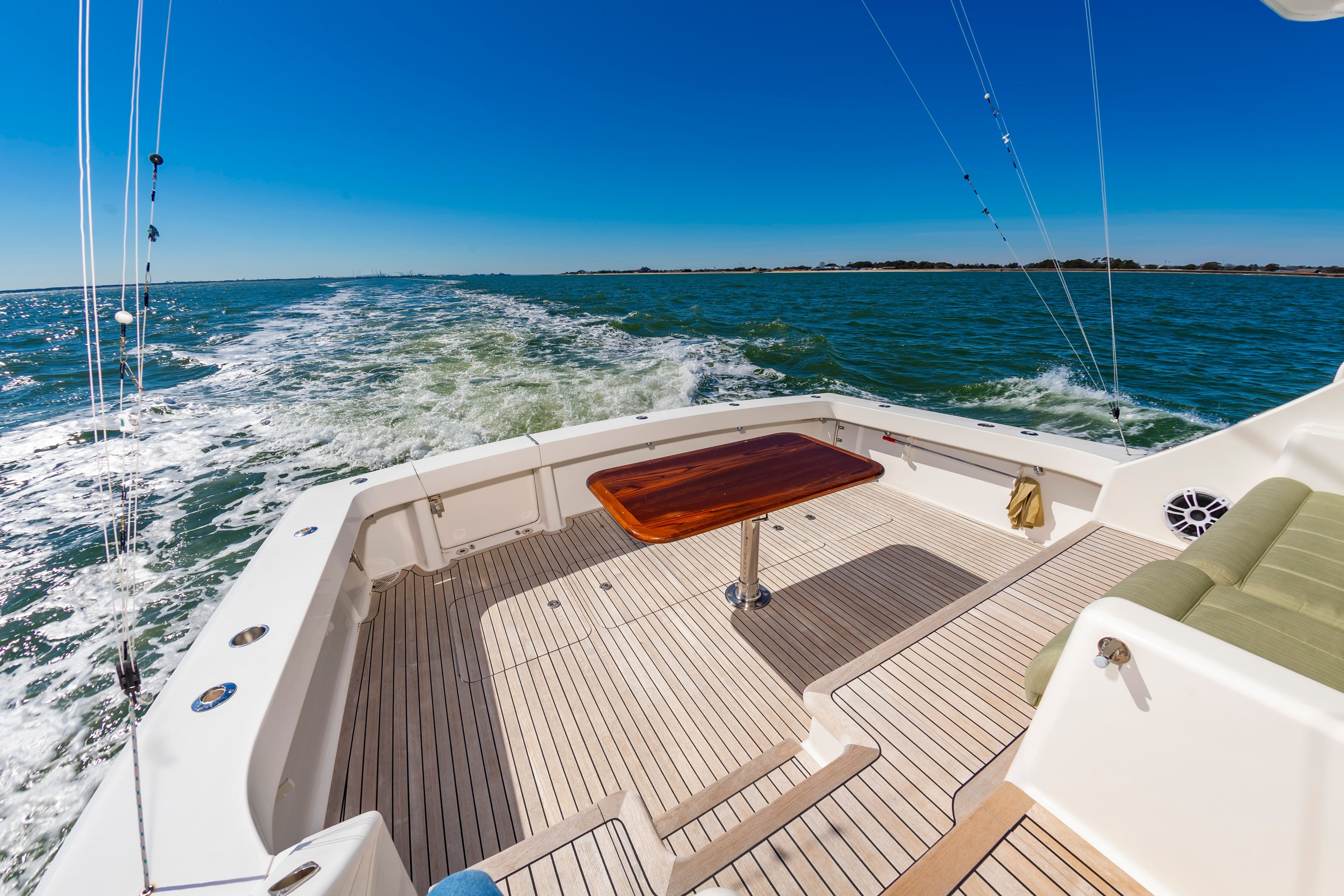 Viking 52 Sport Coupe 2010 cruising on open sea, sunny day.