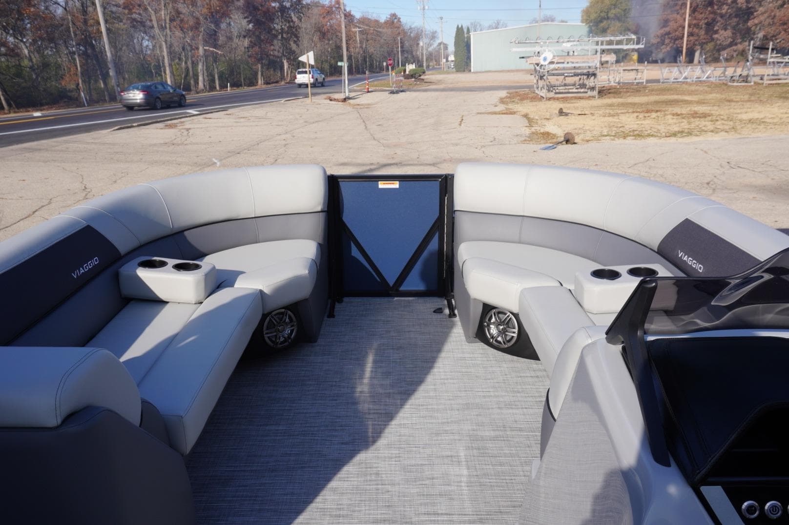2026 Viaggio Lago V-R pontoon boat interior with gray seating and cup holders.