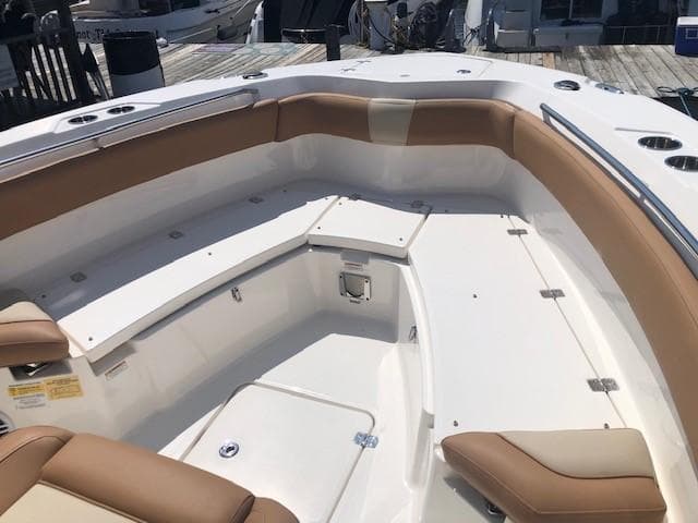 2023 NauticStar 24 XS boat with tan seating and white deck.
