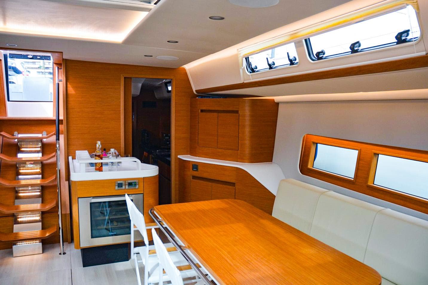 Luxurious interior of 2018 Hanse 675 yacht with modern kitchen and dining area.