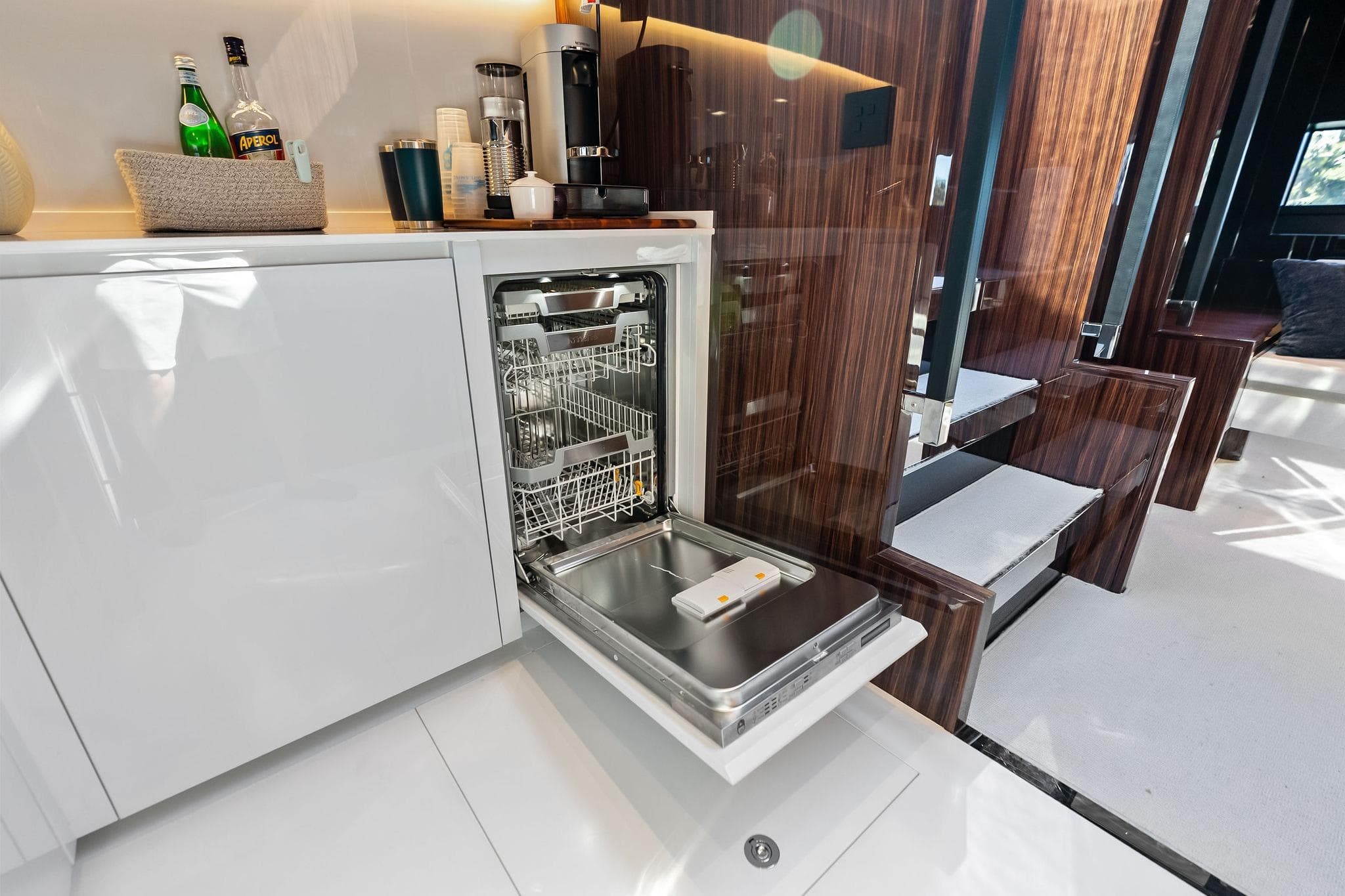 Luxurious interior of 2023 Riva 76 PERSEO Super yacht with open dishwasher.