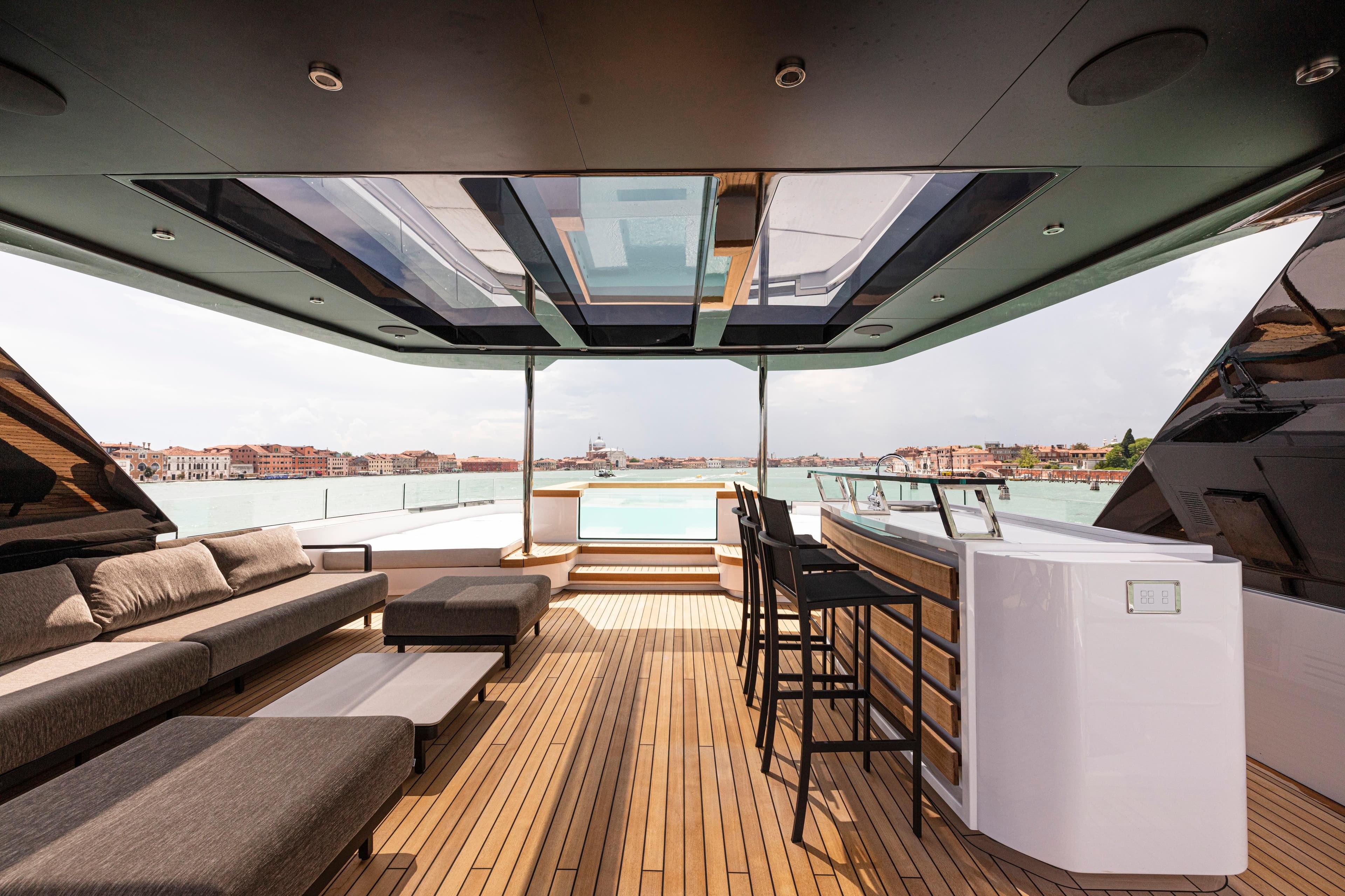 Luxurious Ocean King Ducale 120 yacht deck with seating and bar, 2027 model.