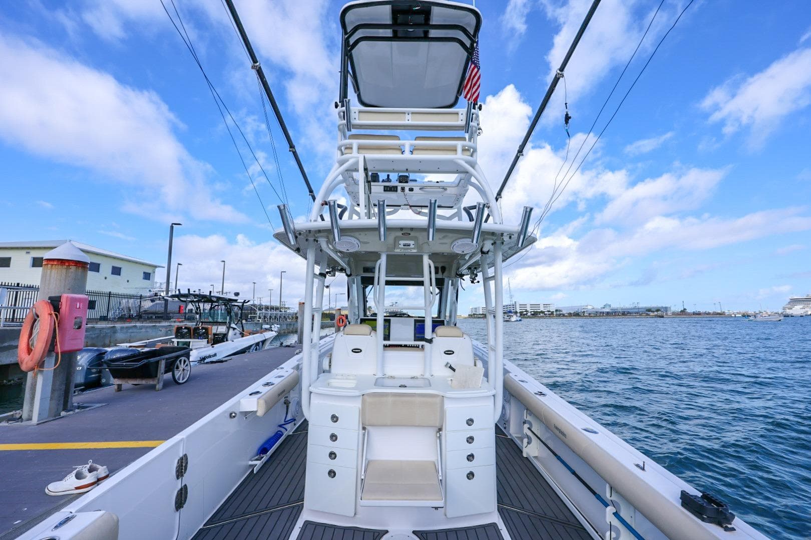 2017 Everglades 355 Center Console boat docked, featuring spacious deck and fishing equipment.