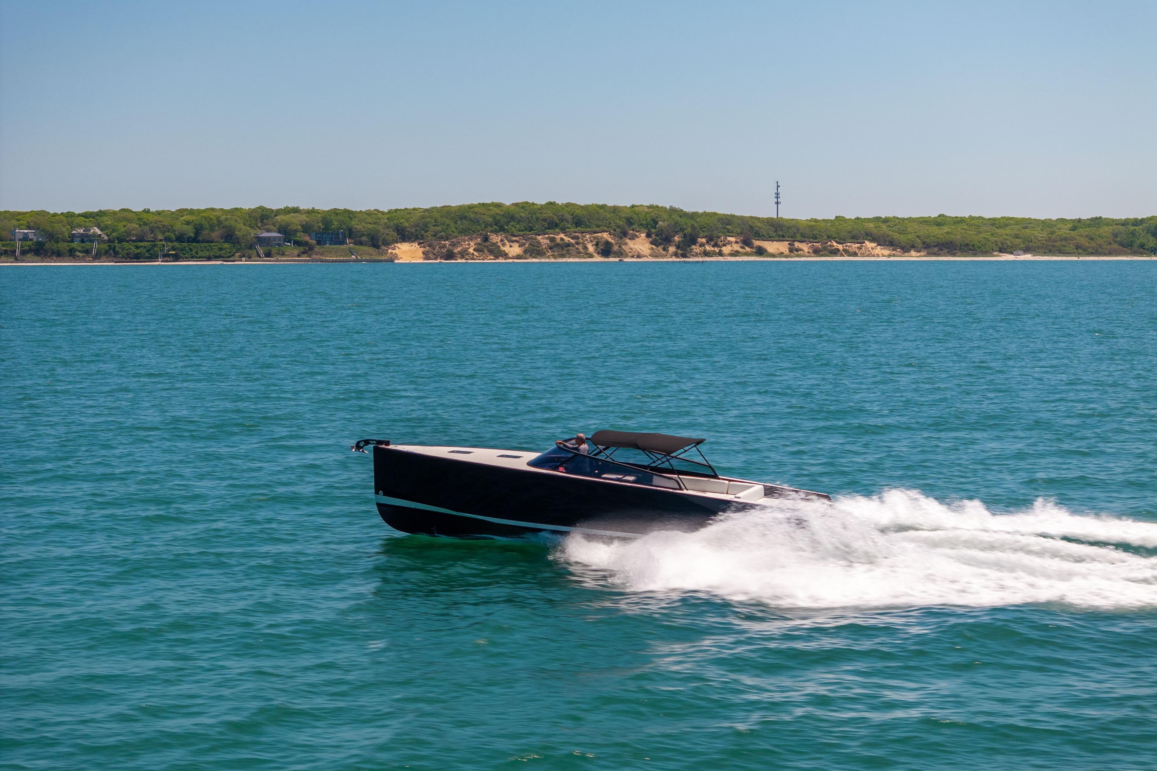 VanDutch 40 yacht cruising on blue waters near a scenic coastline, 2016 model.