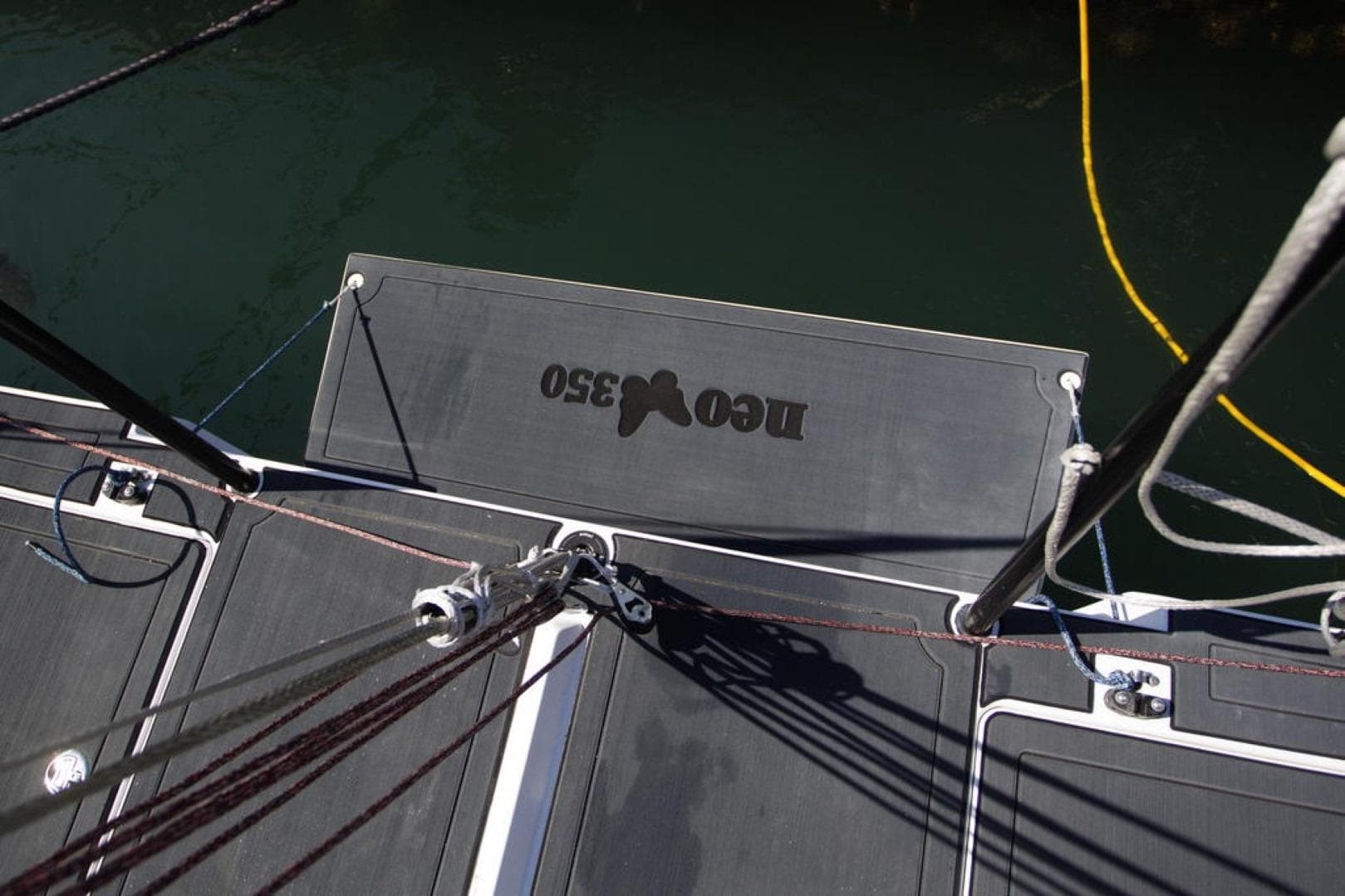 Deck view of a 2018 Neo 350 sailboat with visible rigging and branding.